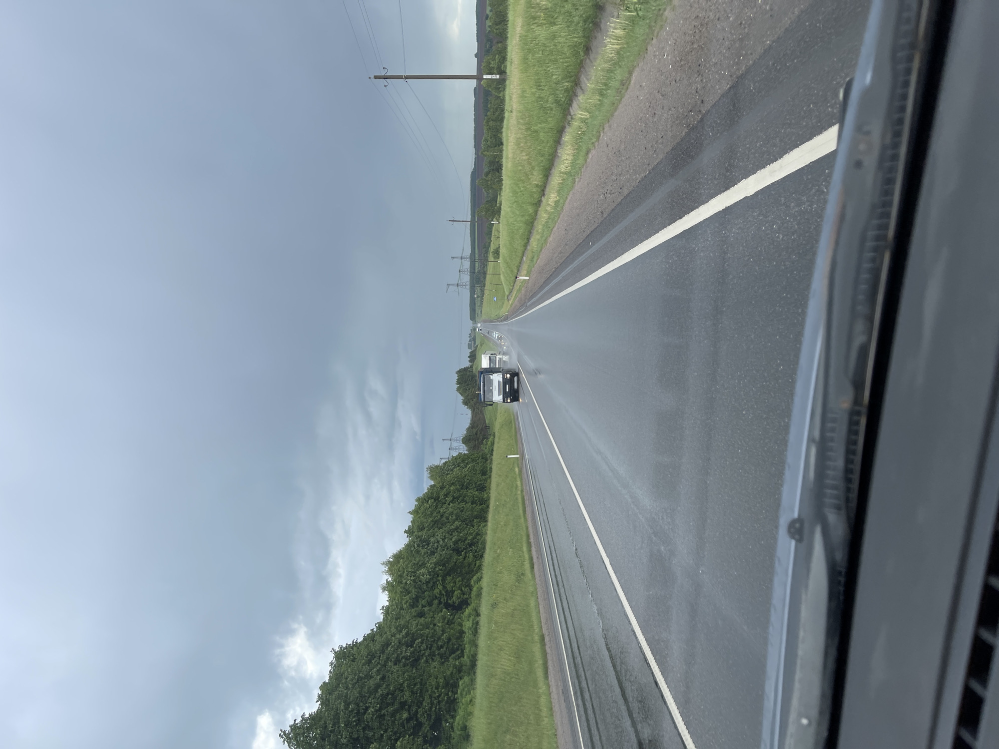 Motorist documents rainy morning drive through rural Кокино, Russia