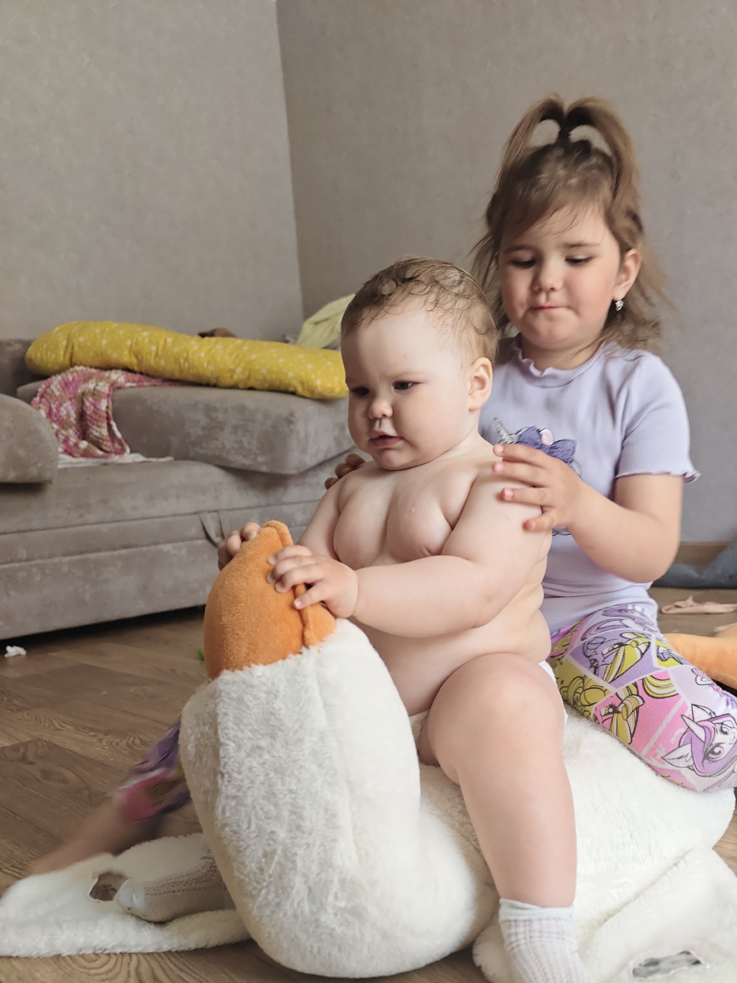 Children play with plush toys at home in Chaikovsky