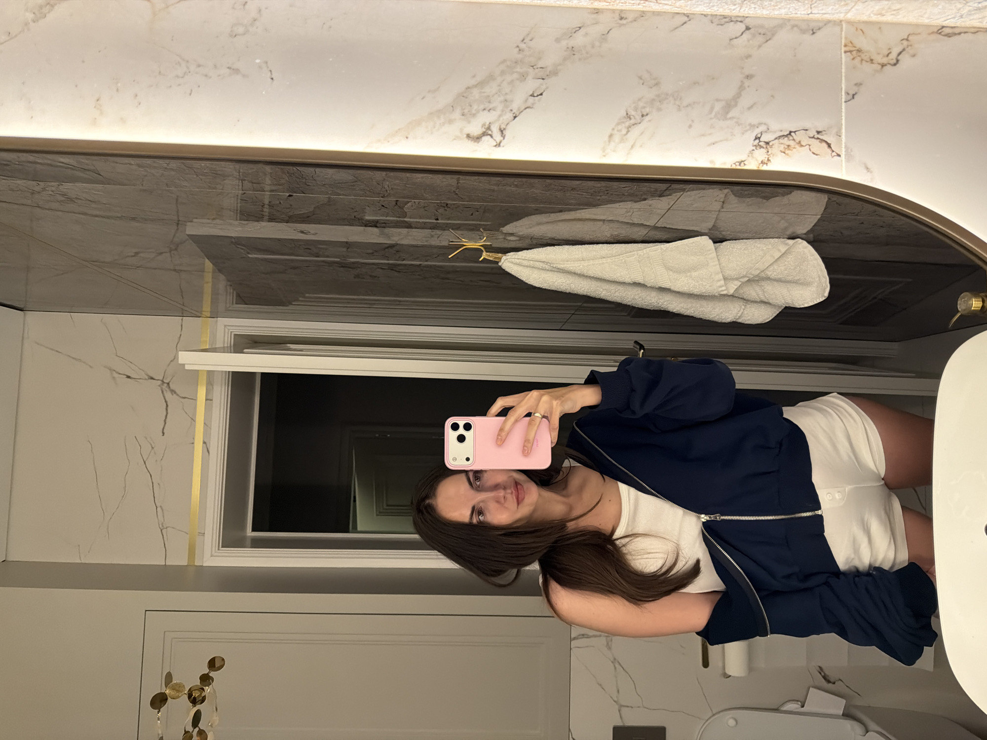 Woman takes bathroom mirror selfie in Krasnoyarsk