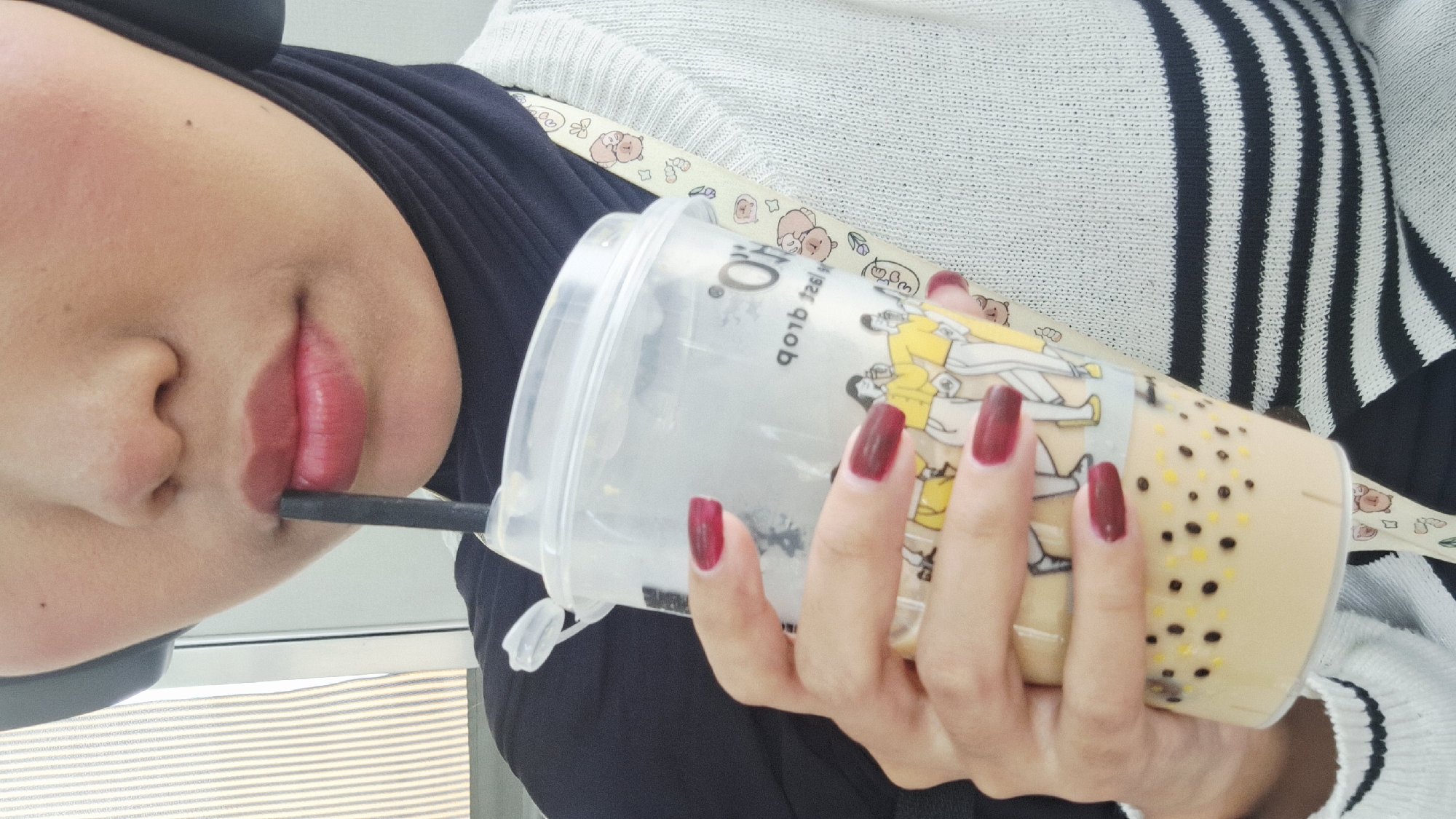 Person enjoys bubble tea in Cikarang street scene