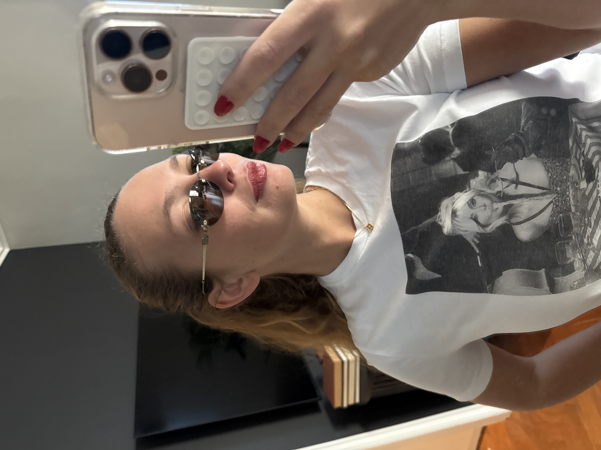 Woman takes multiple selfies indoors in Cape Town