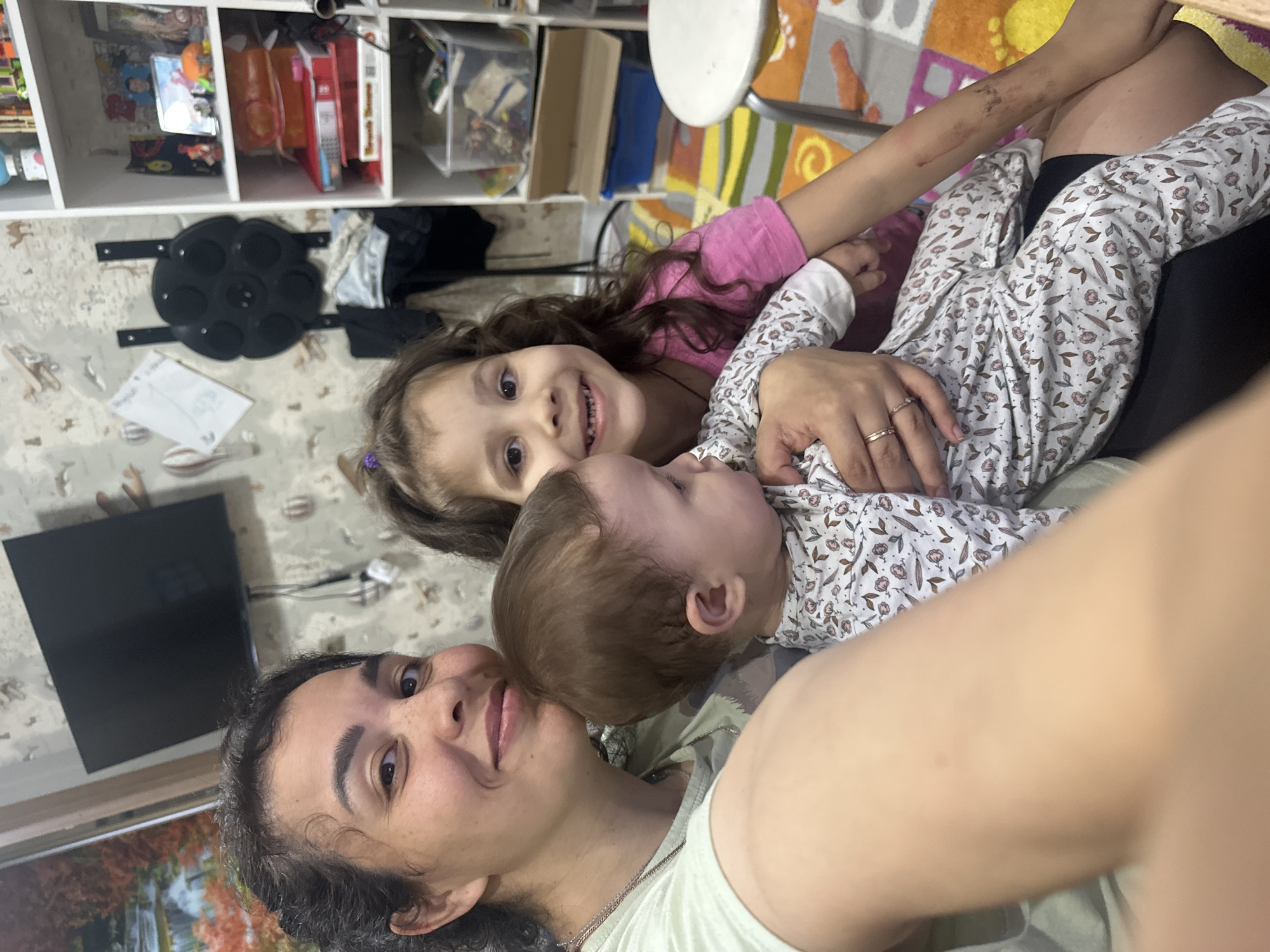 Quiet indoor moment with a baby and young child