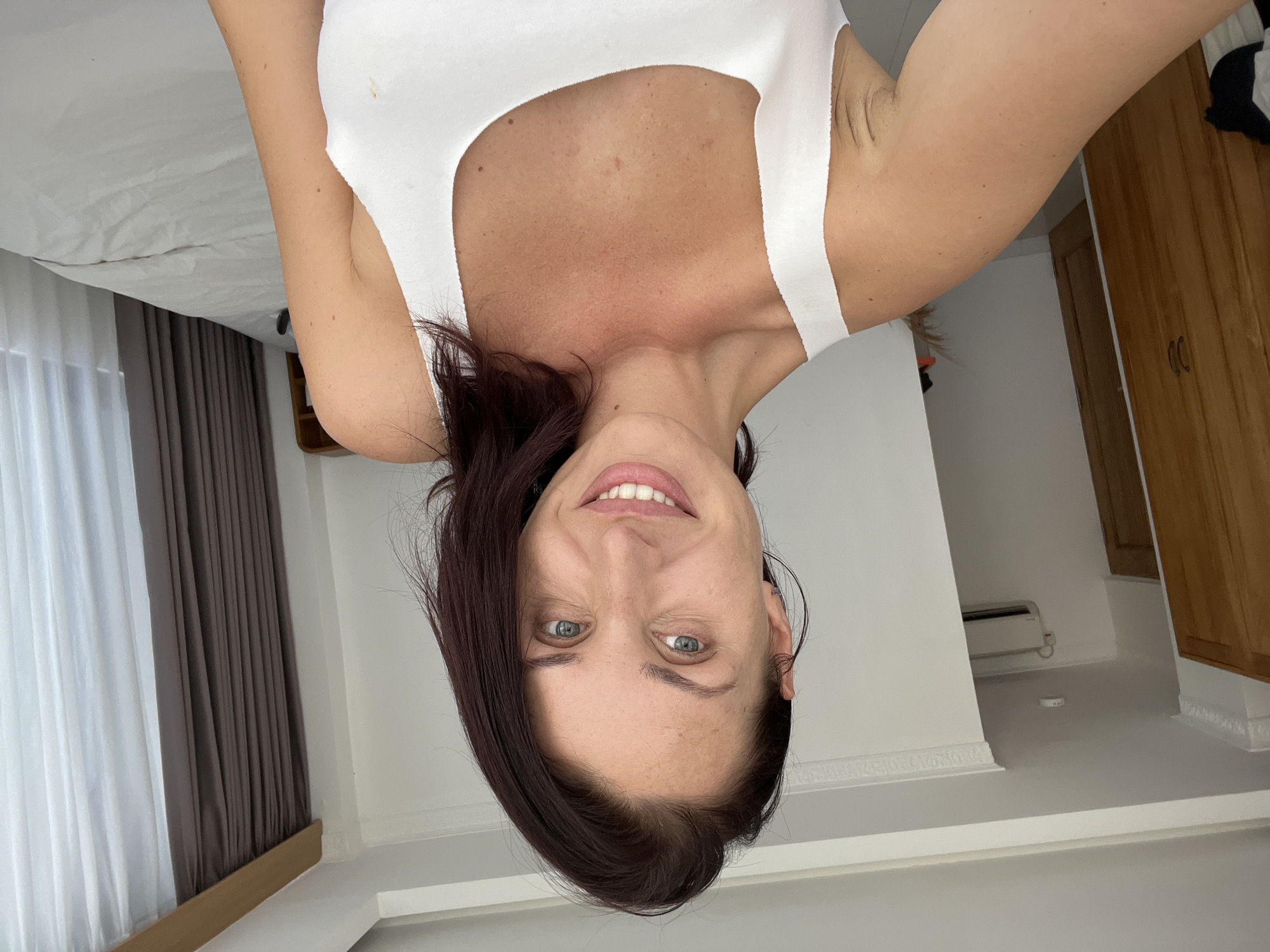 Woman takes upside-down selfies in Kuta Selatan bedroom