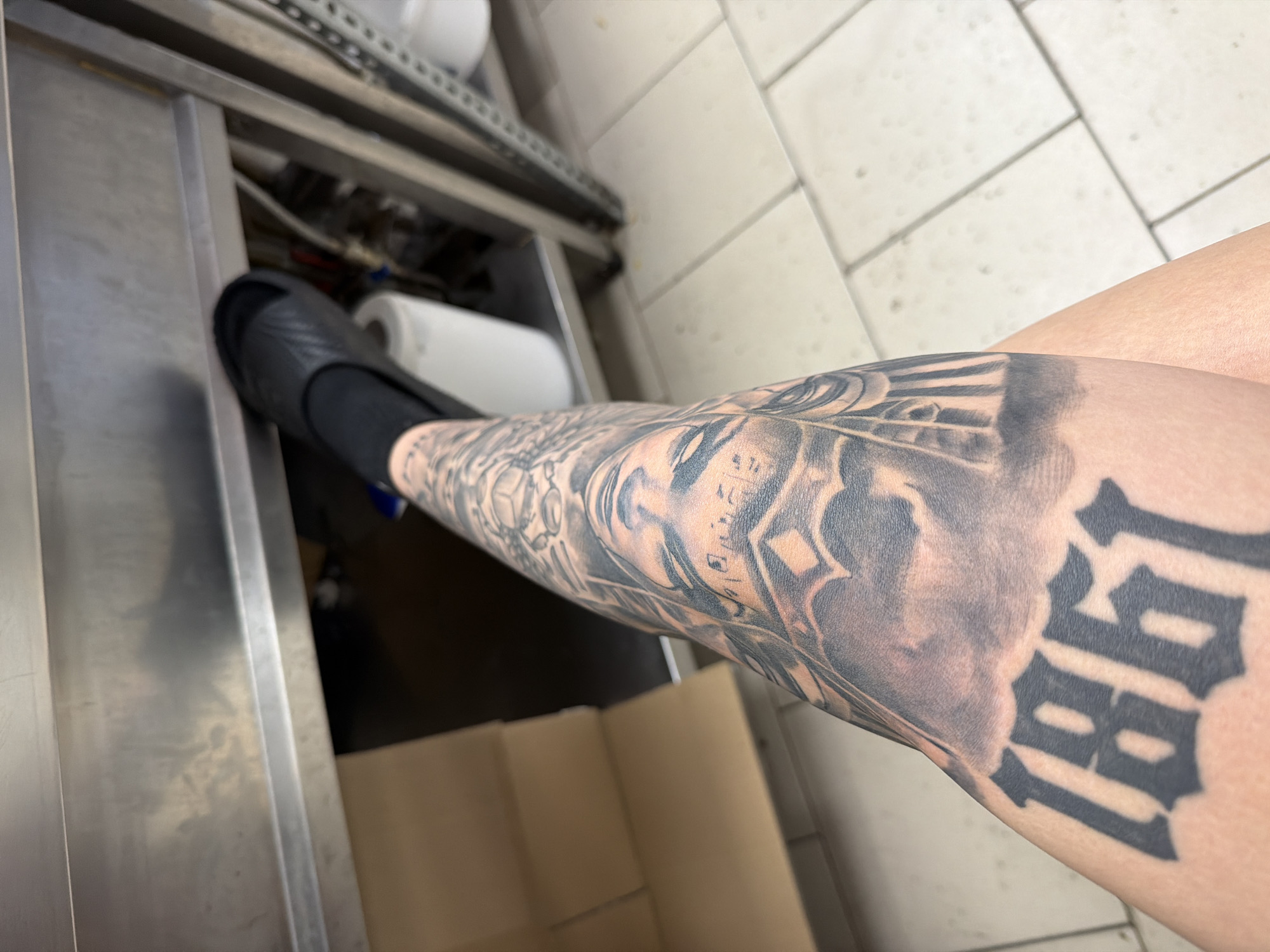 Person with tattooed leg photographed in Plovdiv commercial kitchen