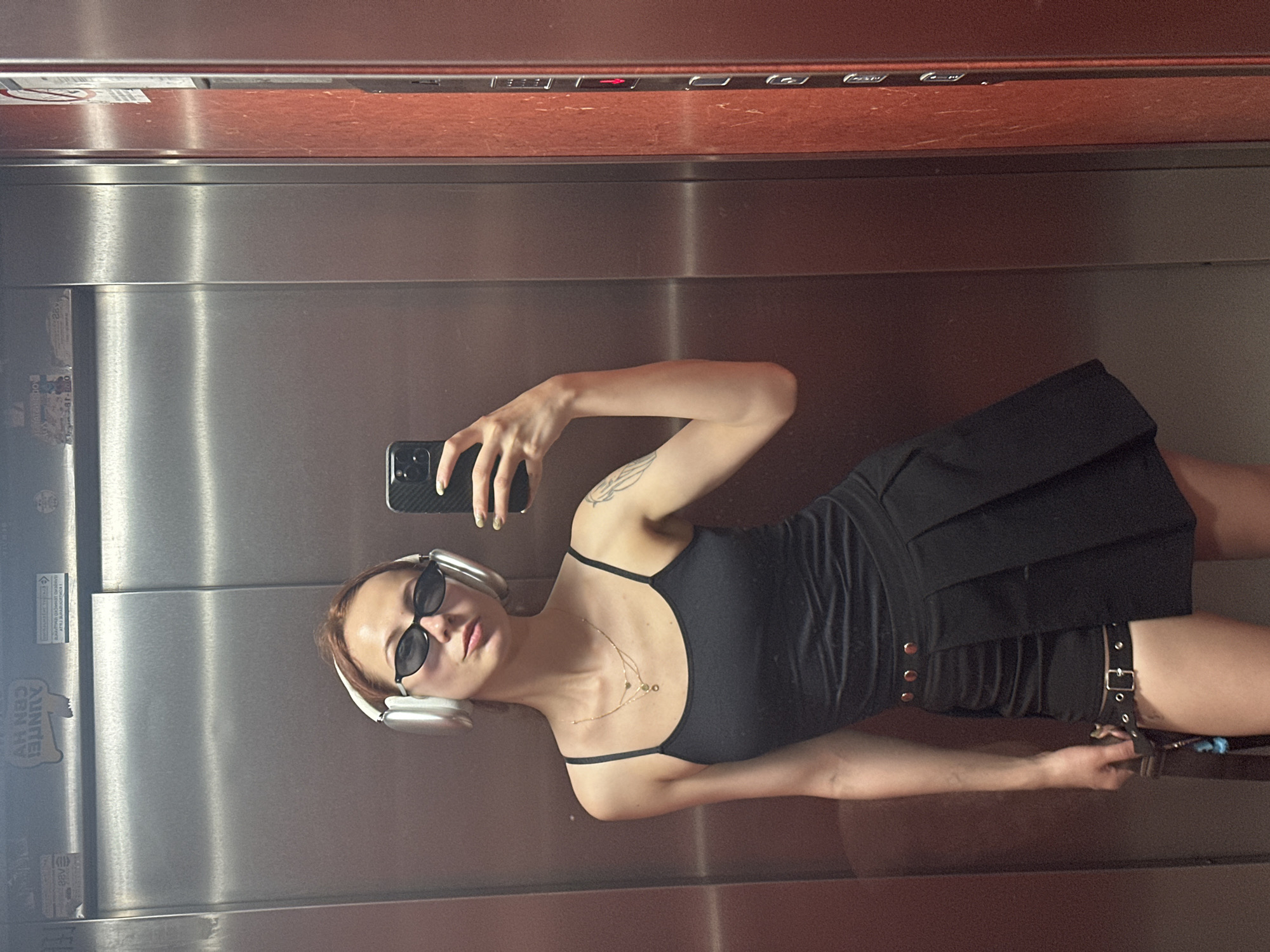 Woman Takes Multiple Elevator Selfies With Plant in Novi Sad