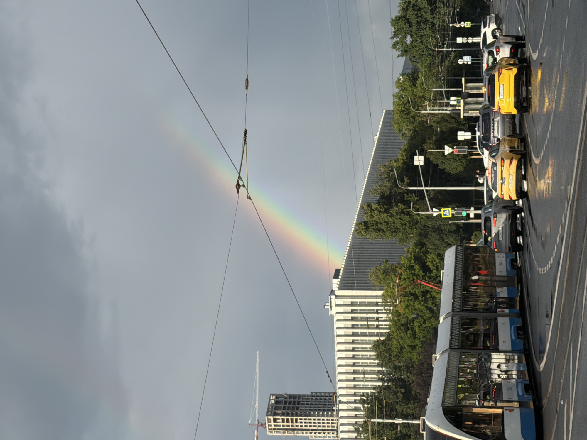 Rainbow over a wet Moscow intersection after summer rain