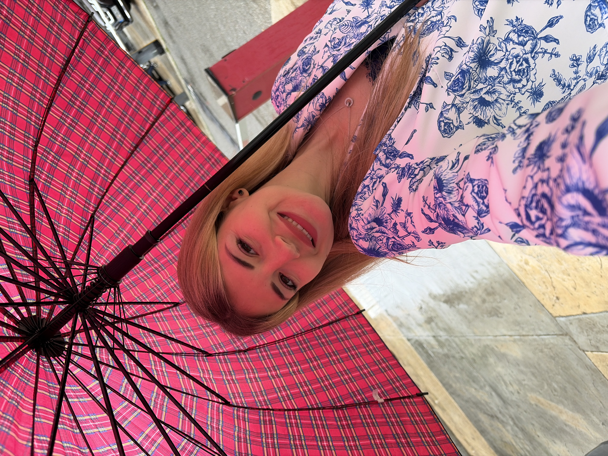 Woman takes umbrella selfies in Budva, Montenegro