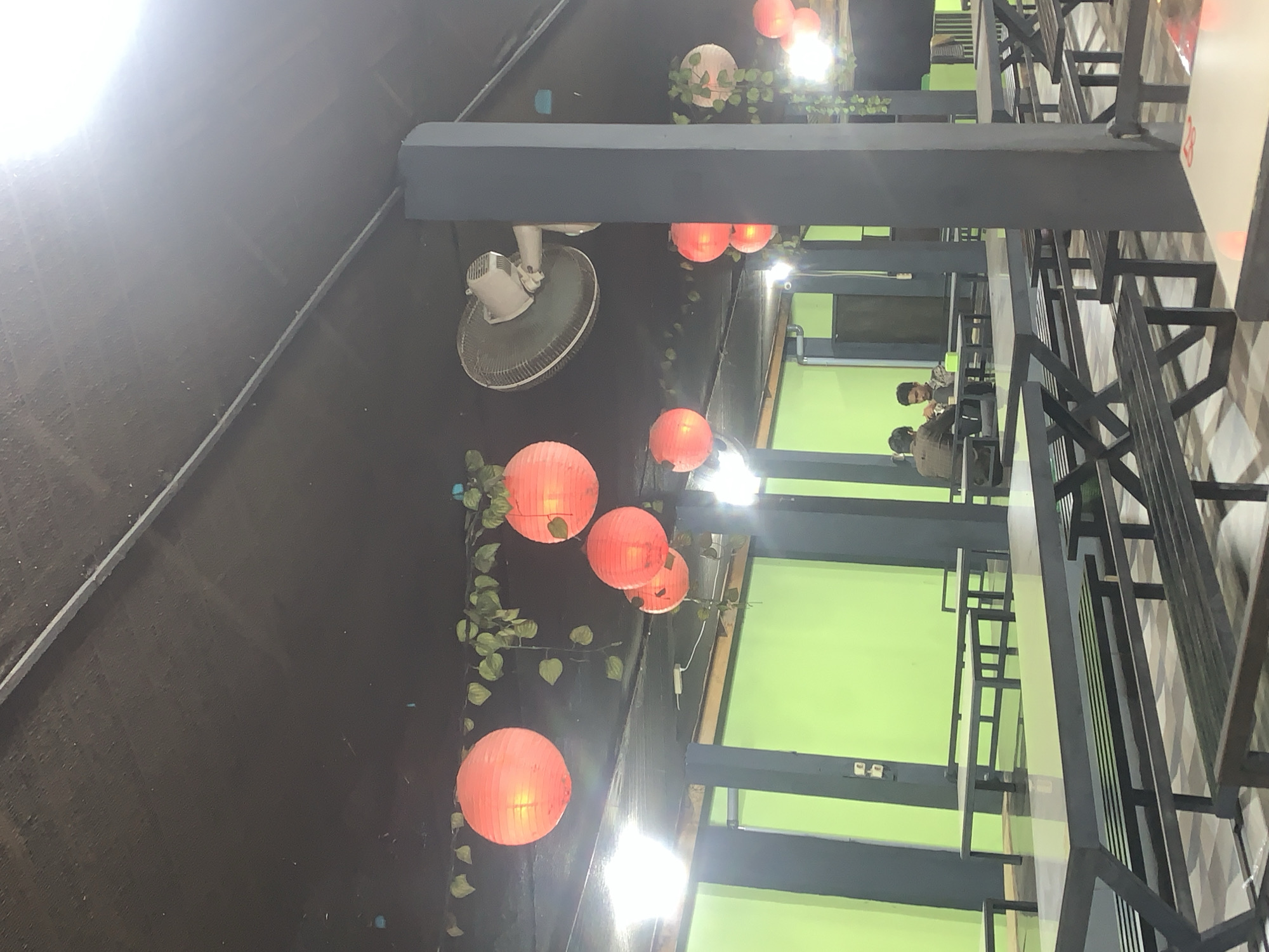 Lantern-lit outdoor dining spot in Palohlada at night