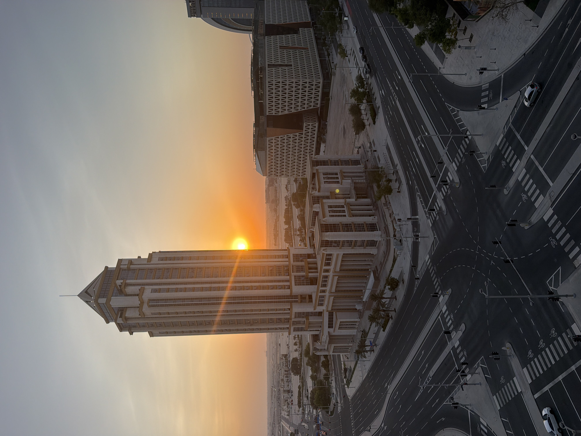 Lusail's modern road grid at golden hour, from above.