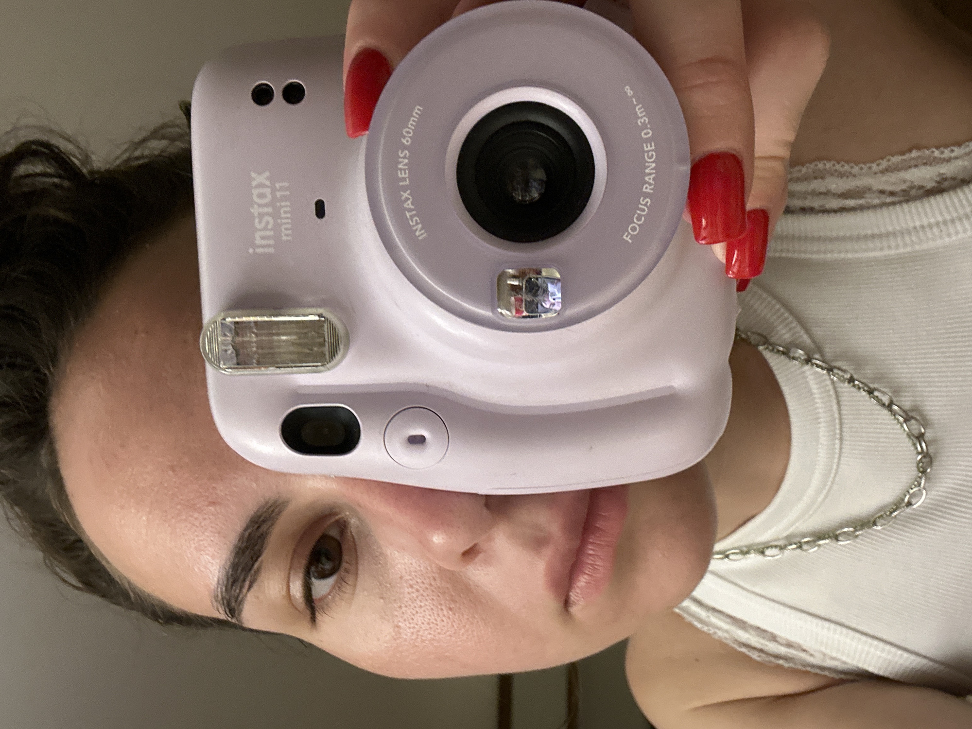 Person with purple camera photographed in Pattaya indoor setting