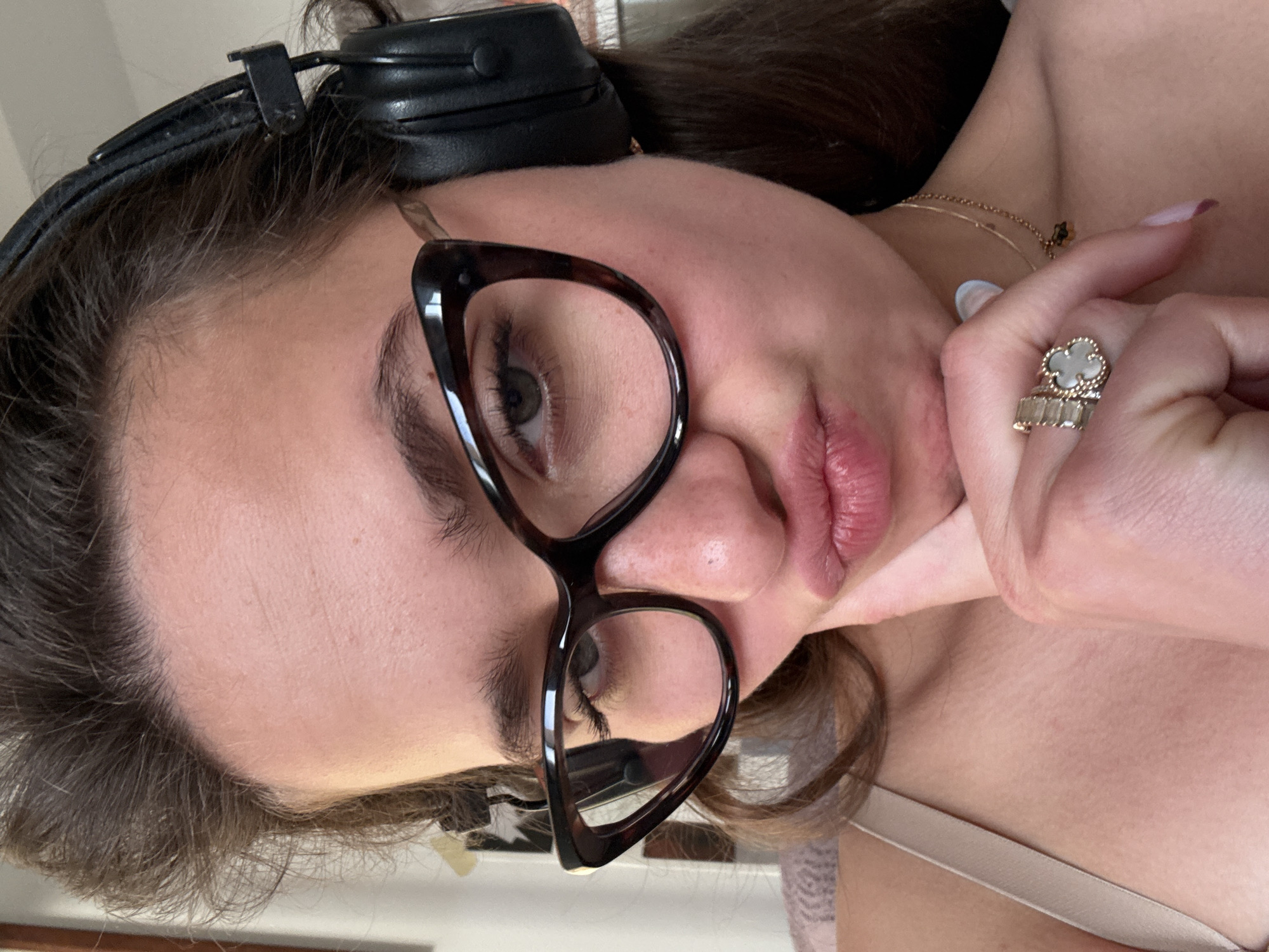 Person takes playful selfies with headphones in Milan