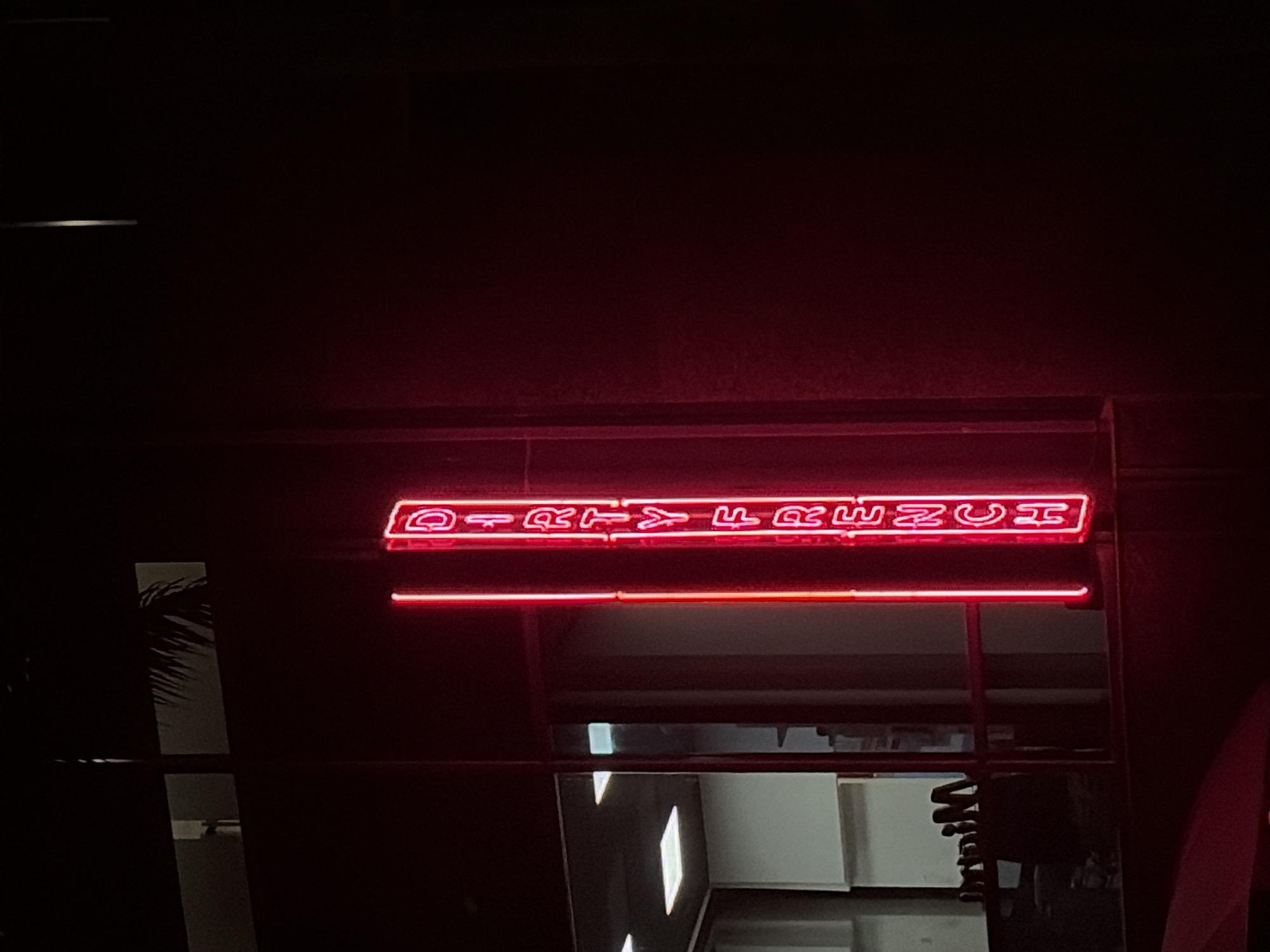 Nighttime Miami scenes show restaurant signage and street traffic