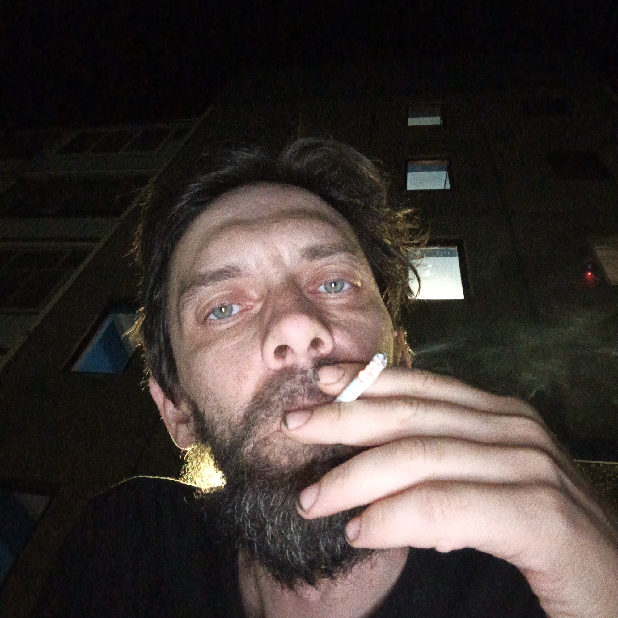 Man photographed smoking outside at night in Марковский, Russia