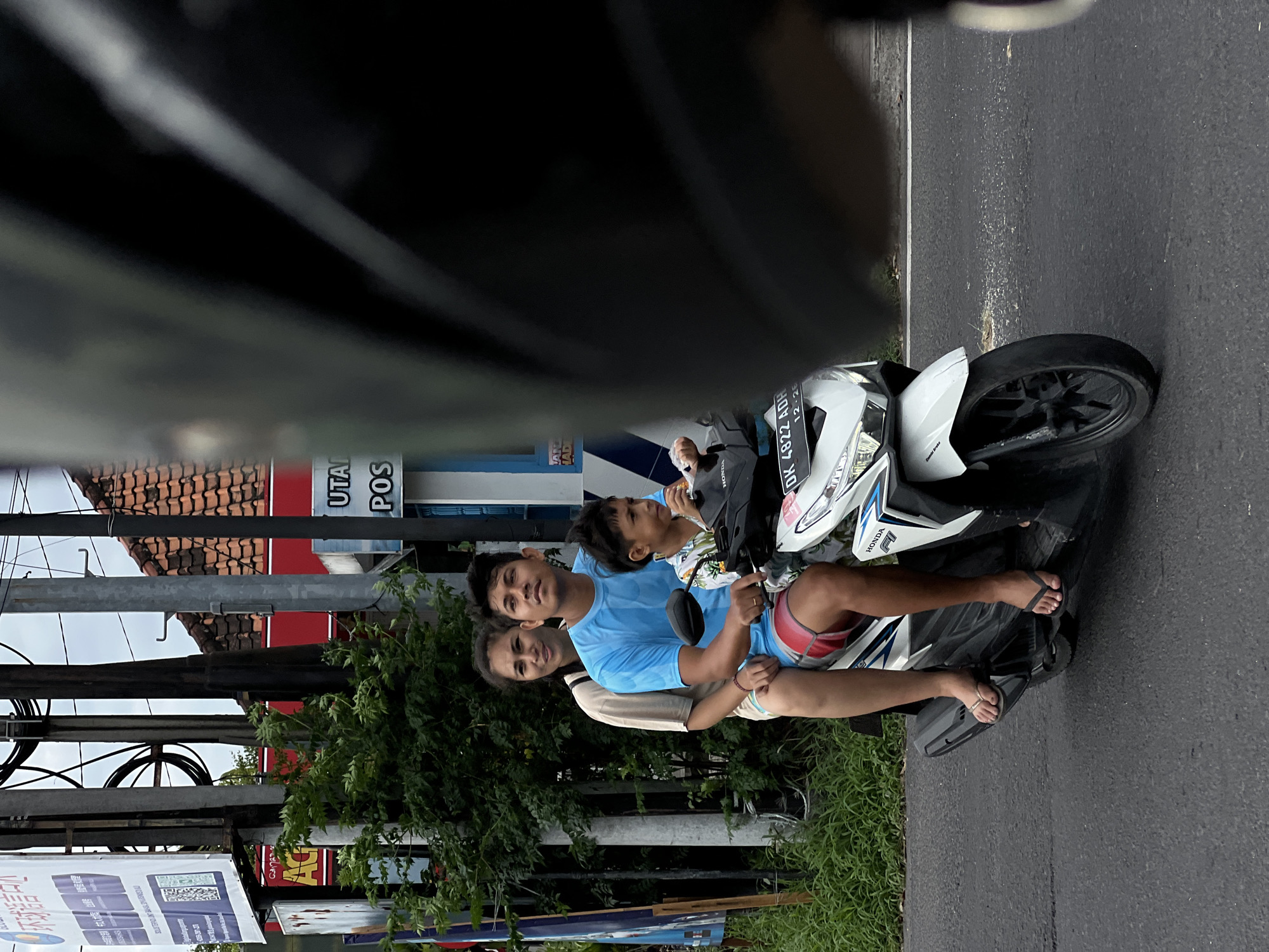 Three riders spotted on white Honda motorcycle in Denpasar