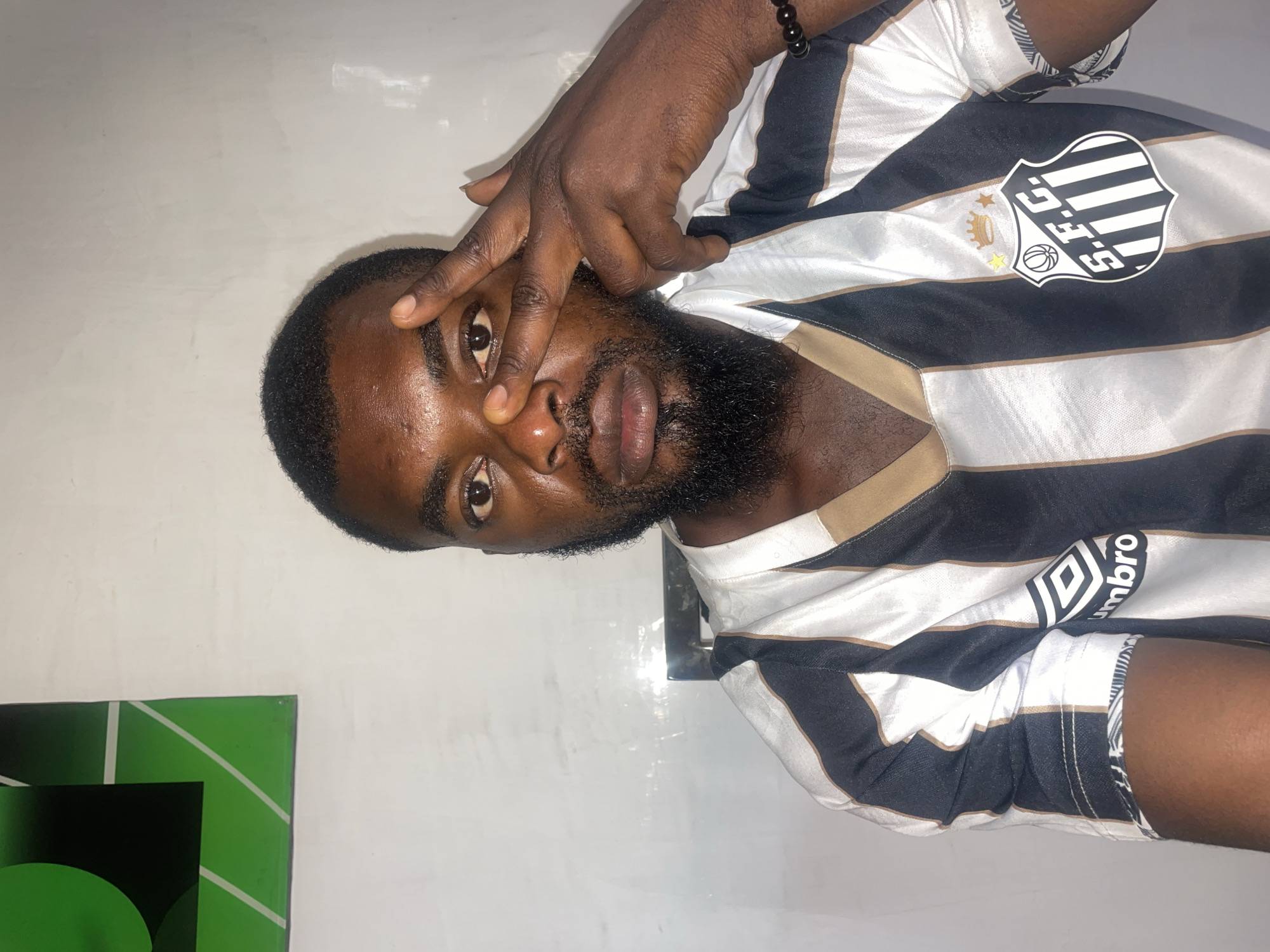 Man in striped jersey enjoys morning drink in Jos