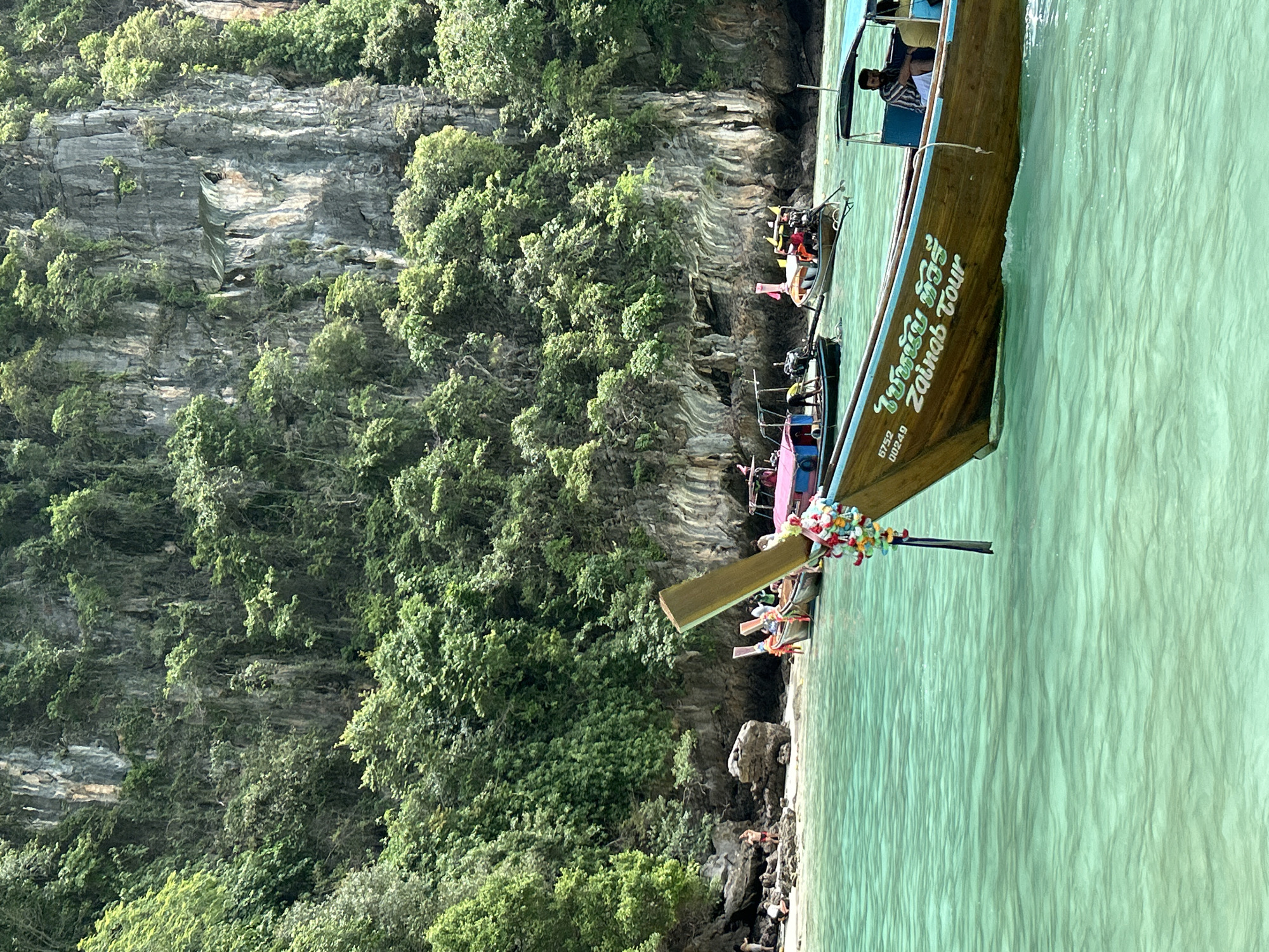Longtail boats weaving through Ao Nang's limestone cliff waters