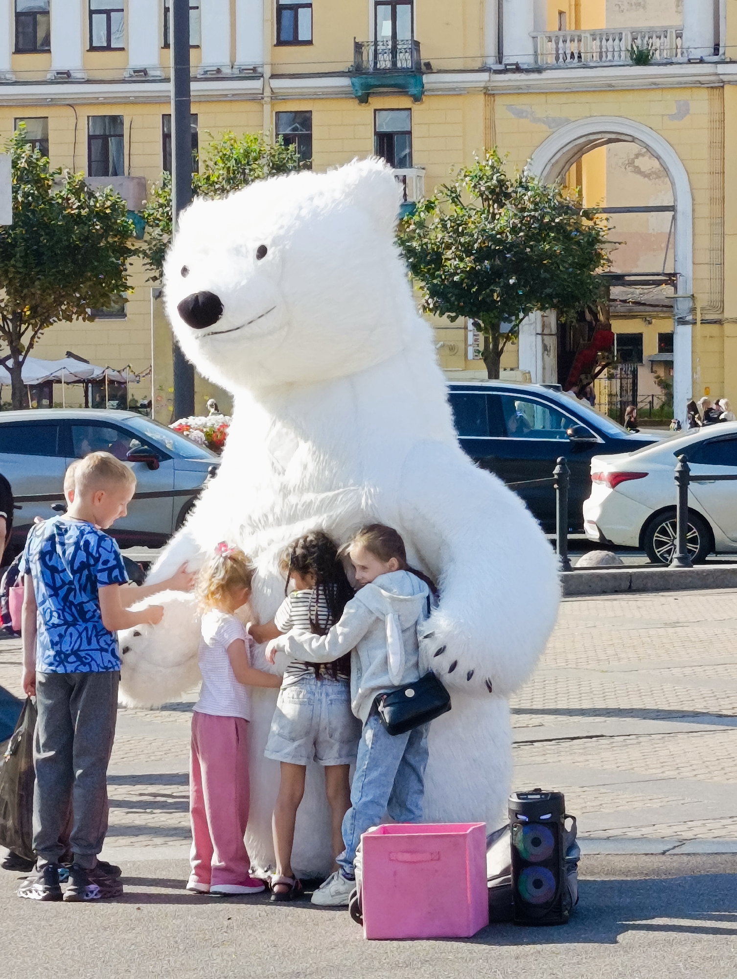 Polar bear mascot meets kids on a Saint Petersburg street