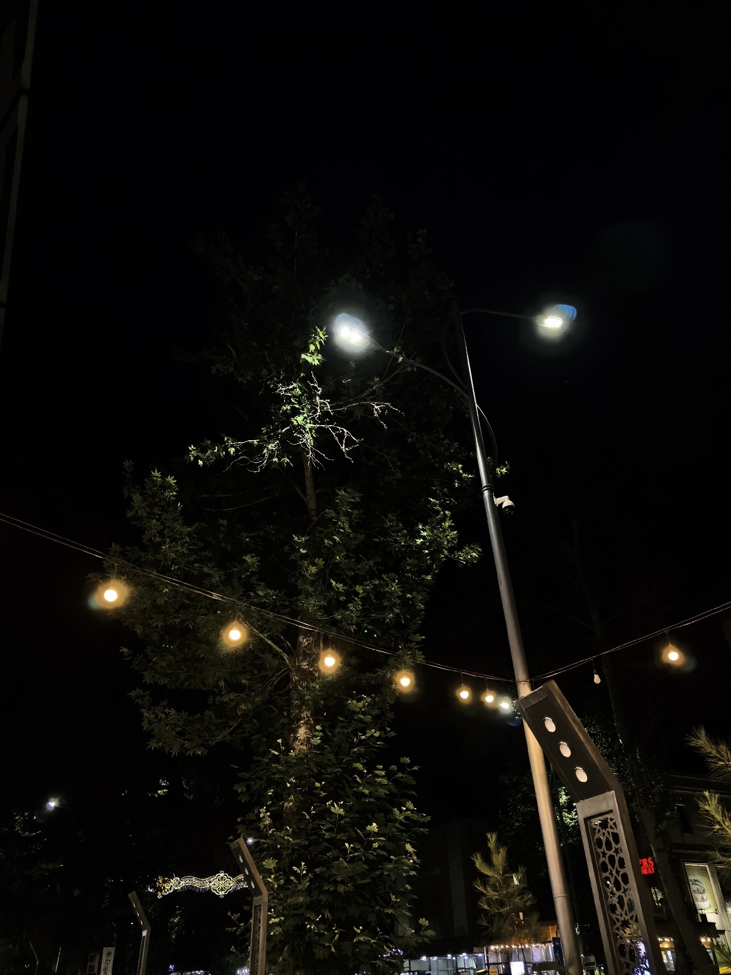 Fergana City at night: street markets, waste collection, and lit storefronts