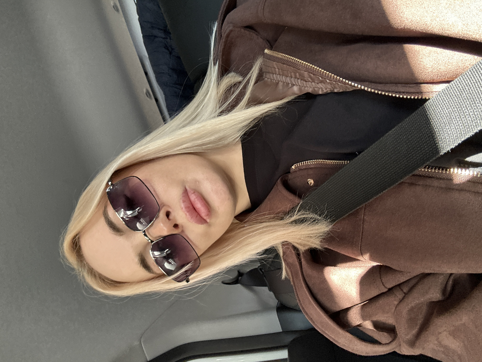 Woman in sunglasses observed in vehicle in Megion