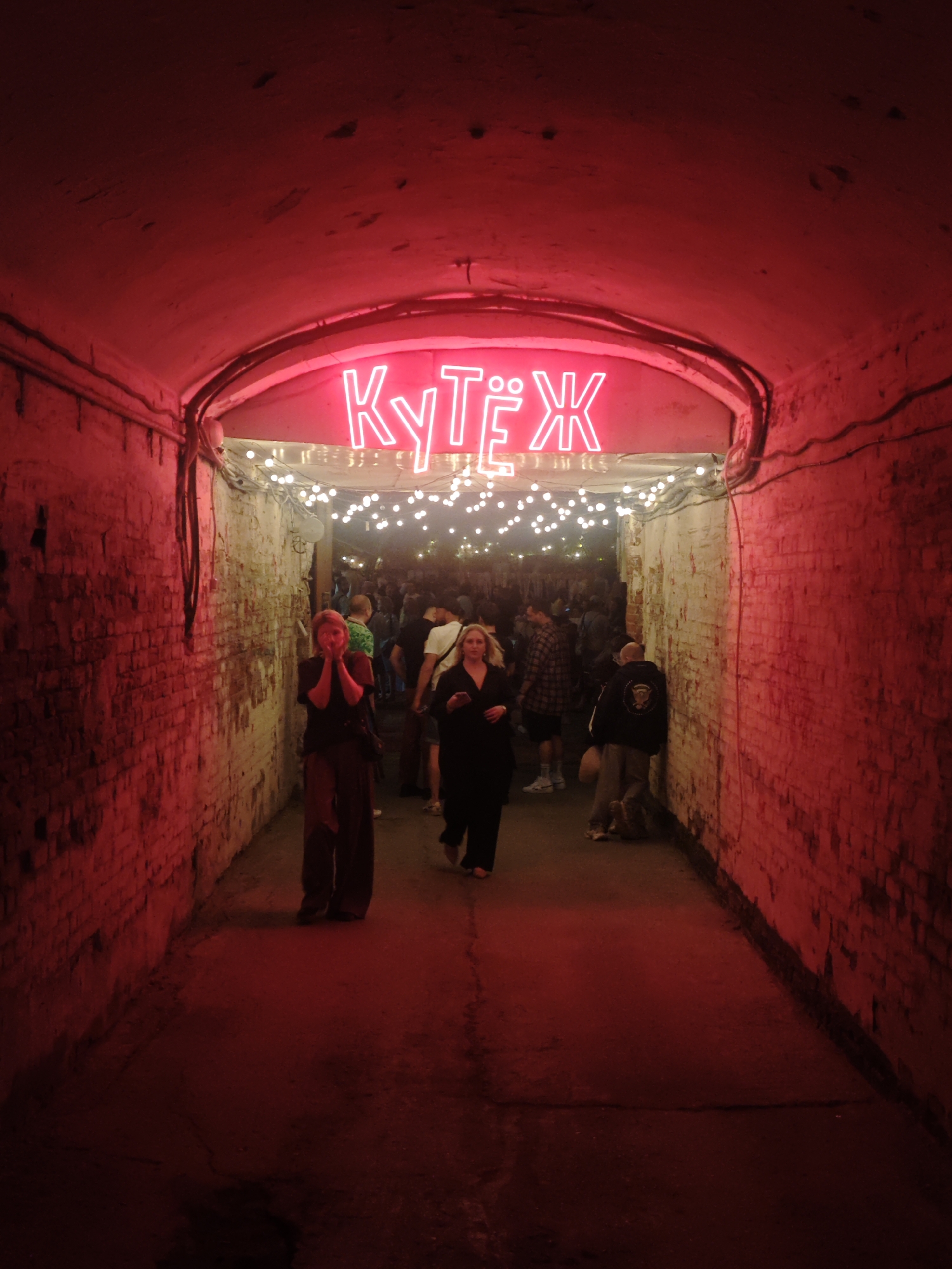 Evening crowds gather in illuminated Samara streets and tunnel