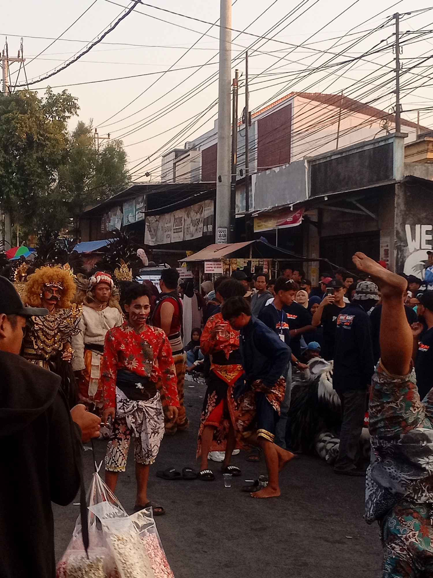 Street parade with marching bands and traditional performers in Margoyoso