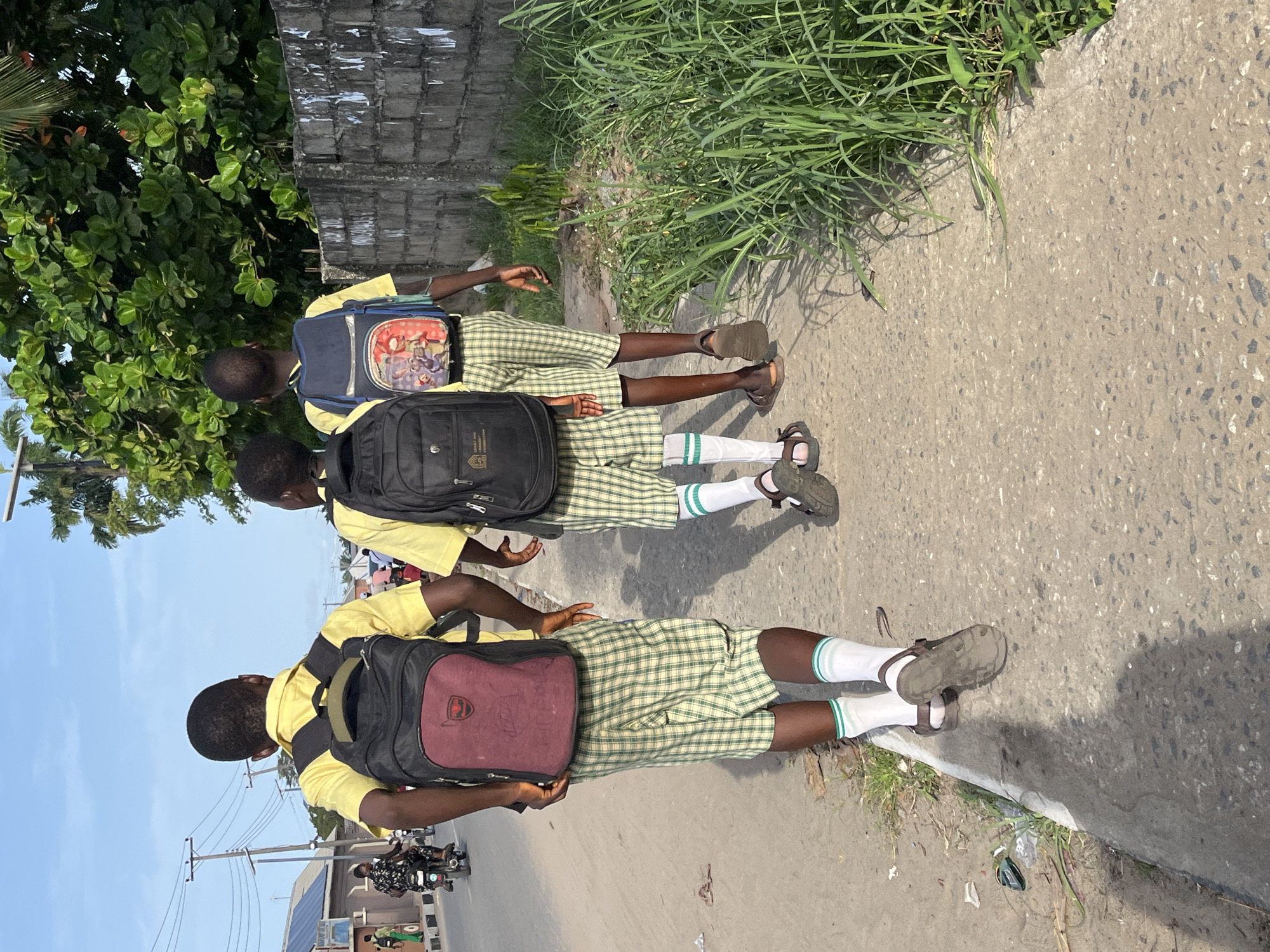 School children in uniforms walk streets of Badagry Nigeria
