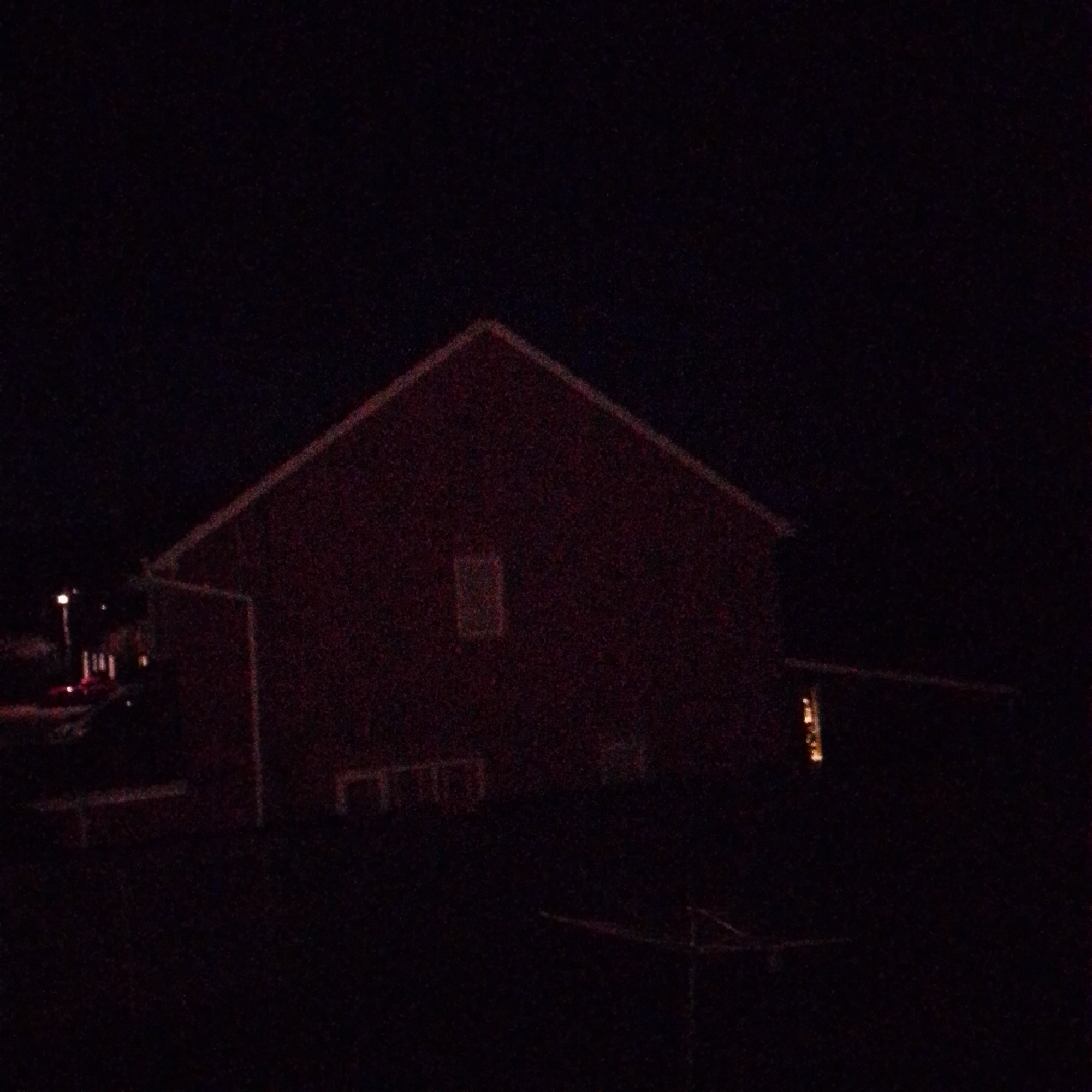Red barn building photographed at night in Corby