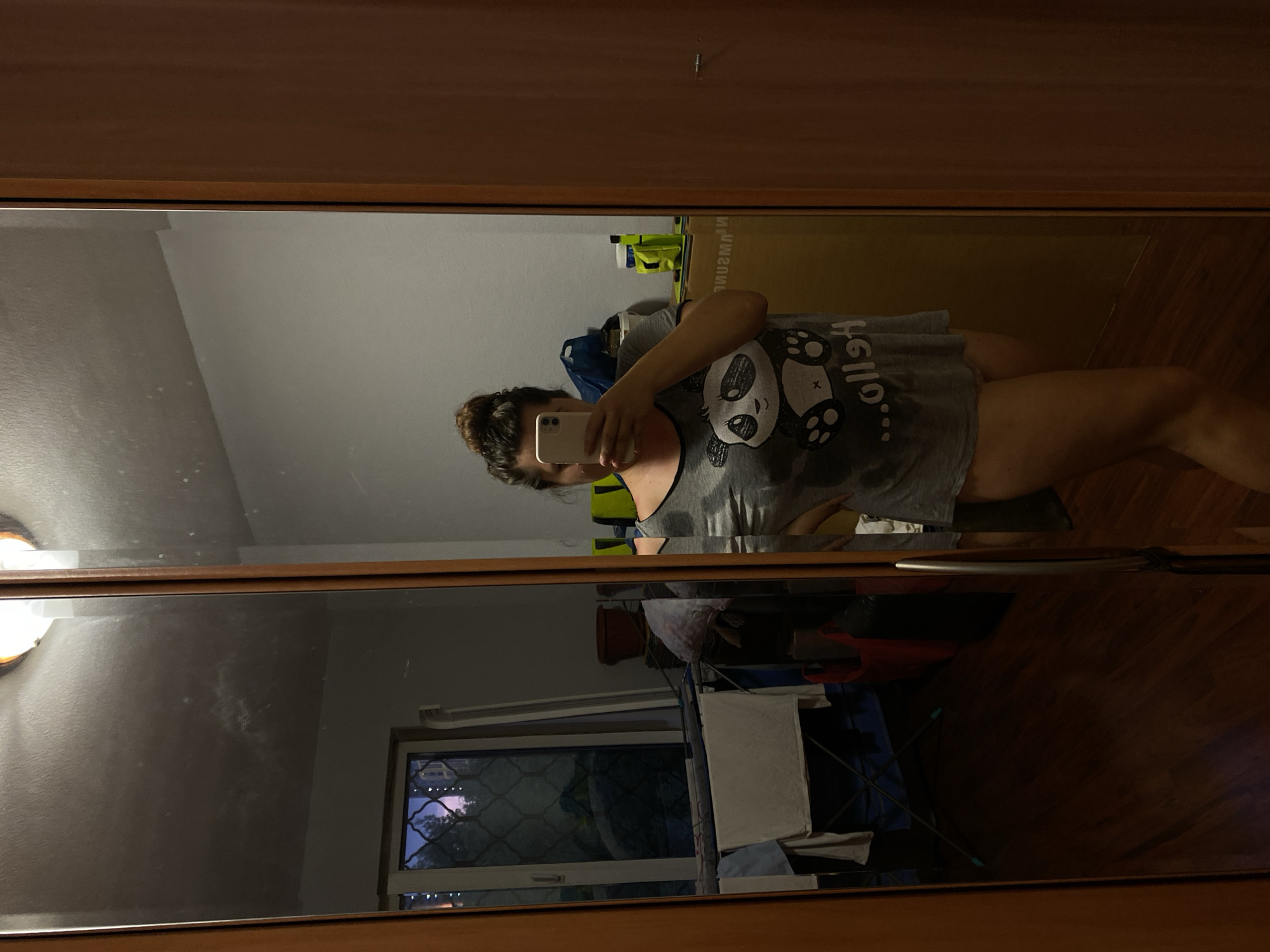 Mirror reflection in a Perm room, panda tee and bun