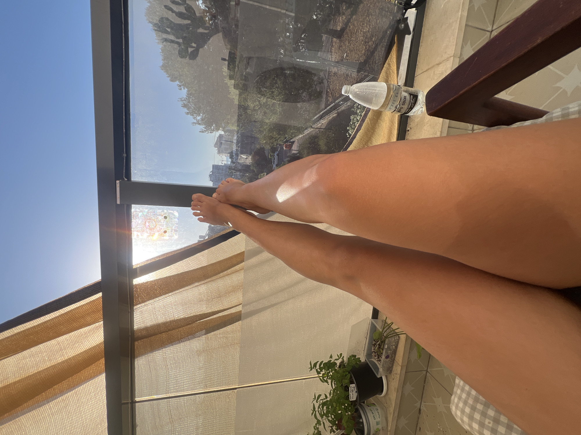 Person relaxes on sunny balcony in Kiryat Bialik