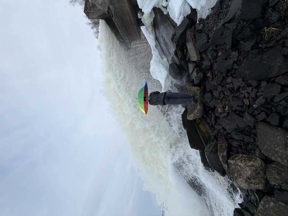 Visitors pose at dramatic waterfall site in Chernushka, Russia