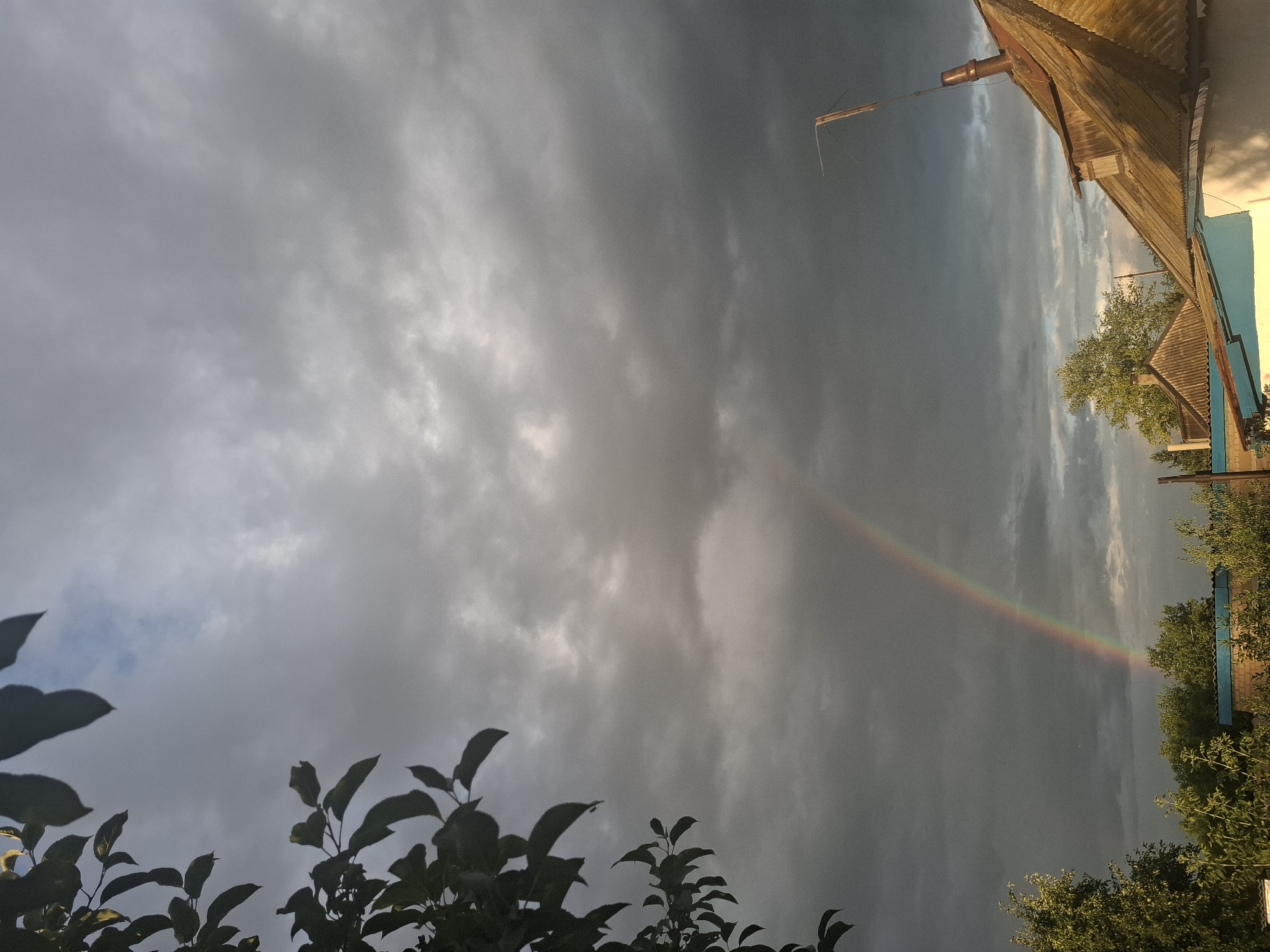 Rainbow breaks through storm clouds over Atbasar's flat terrain