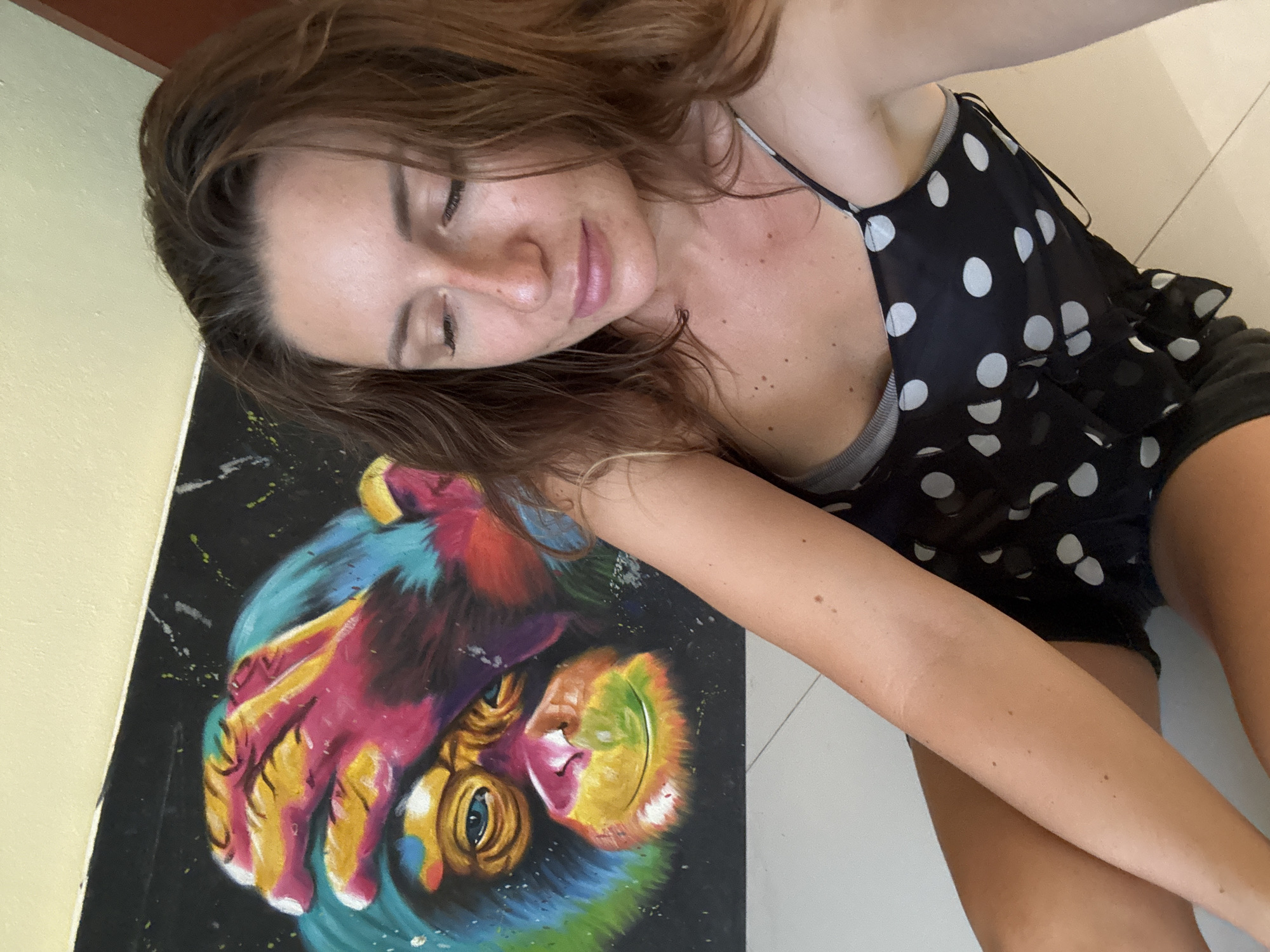 Tropical streets, blooming trees, a monkey painting, and a sleepy cat
