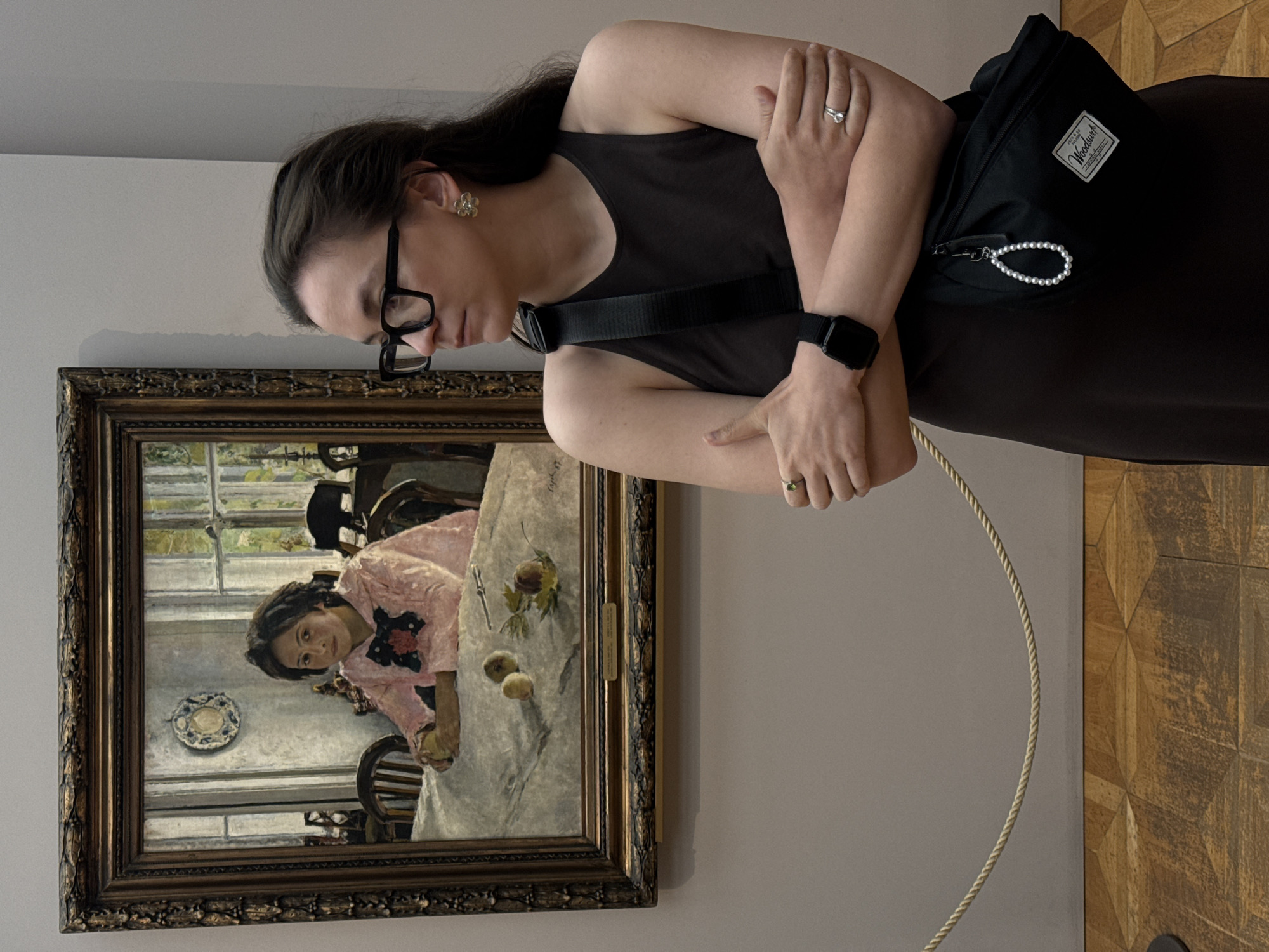 Woman views framed artwork in Moscow gallery or museum