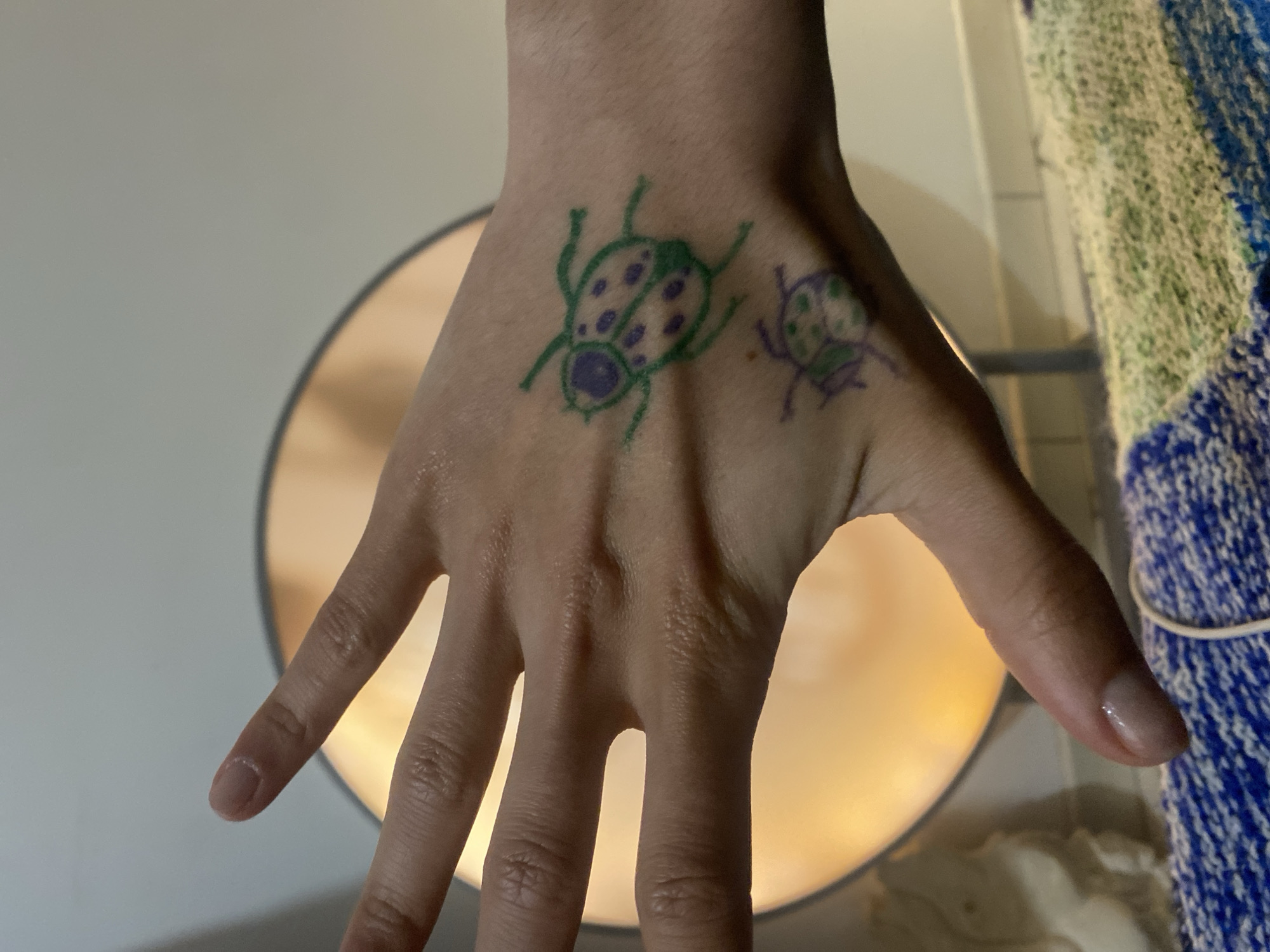 Hand art features colorful ladybug drawings in Aubervilliers