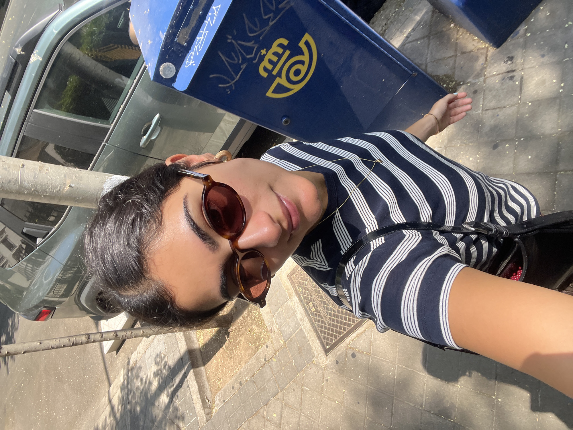 Selfie moment on a Madrid sidewalk, two angles.