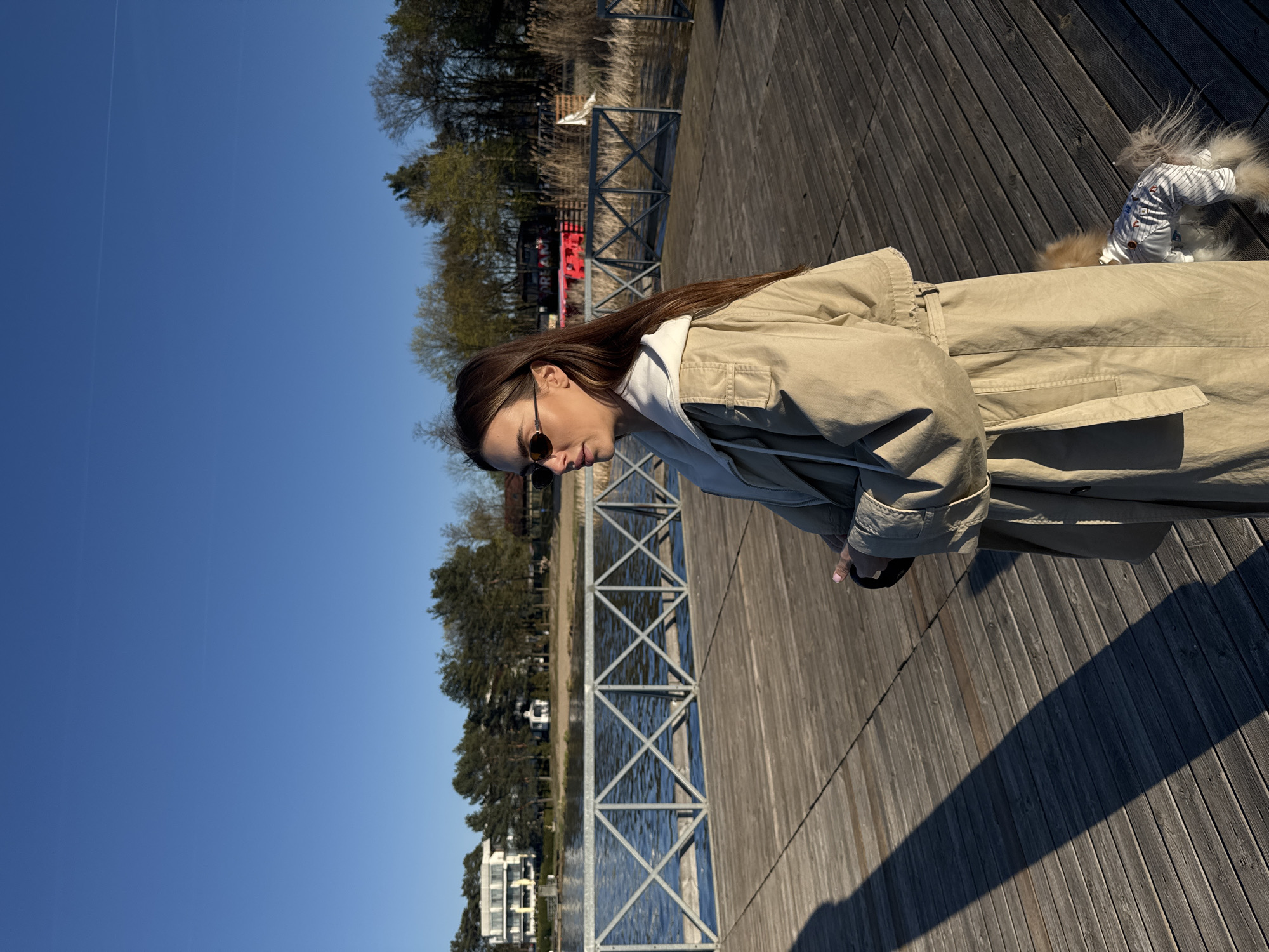 Woman and dressed dog spotted on pier in Białobrzegi