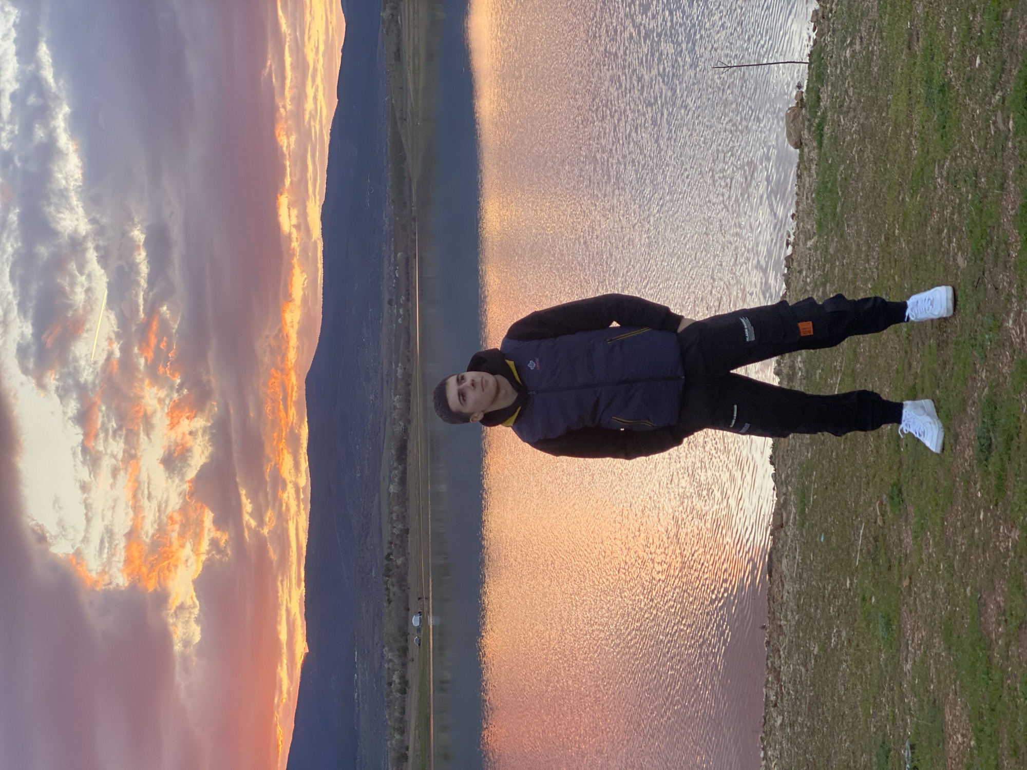 Man stands by lake shore in Kyustendil, Bulgaria