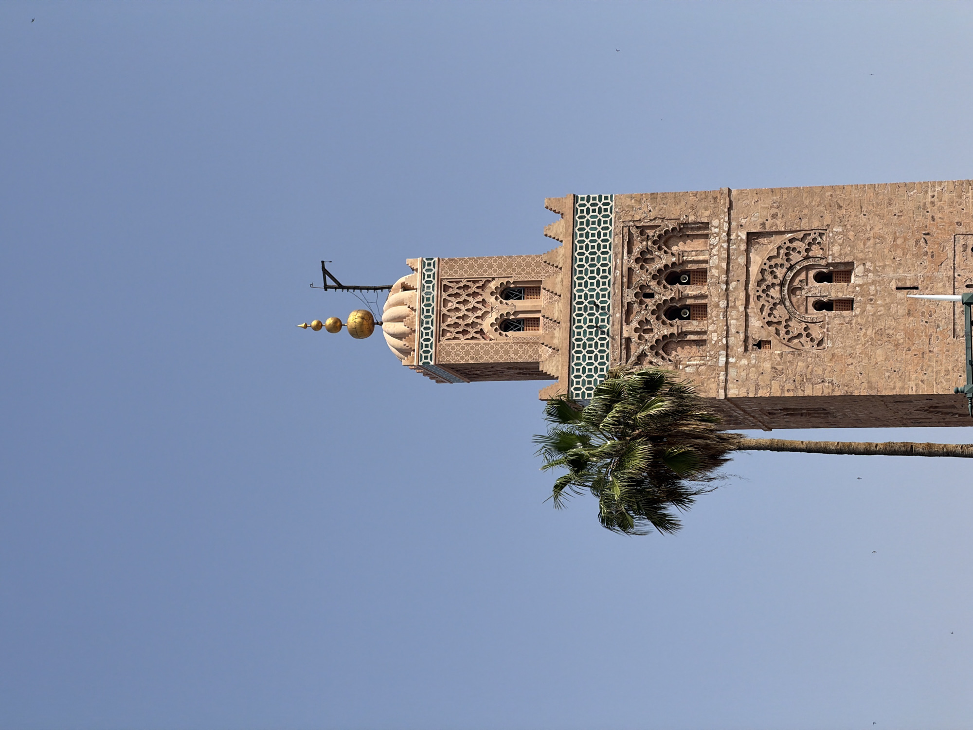 Historic minaret tower documented in Marrakesh under clear skies