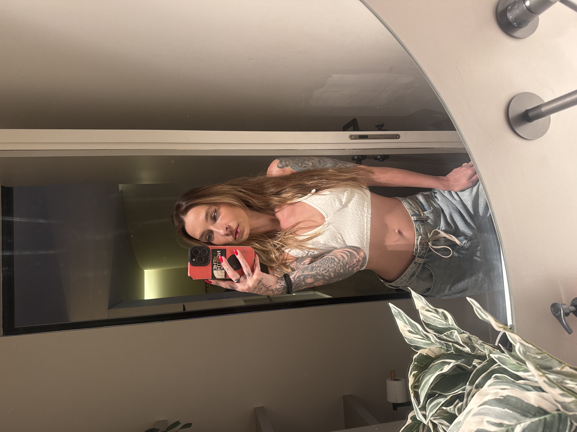 Woman Takes Bathroom Selfies in Modern Tel Aviv Setting