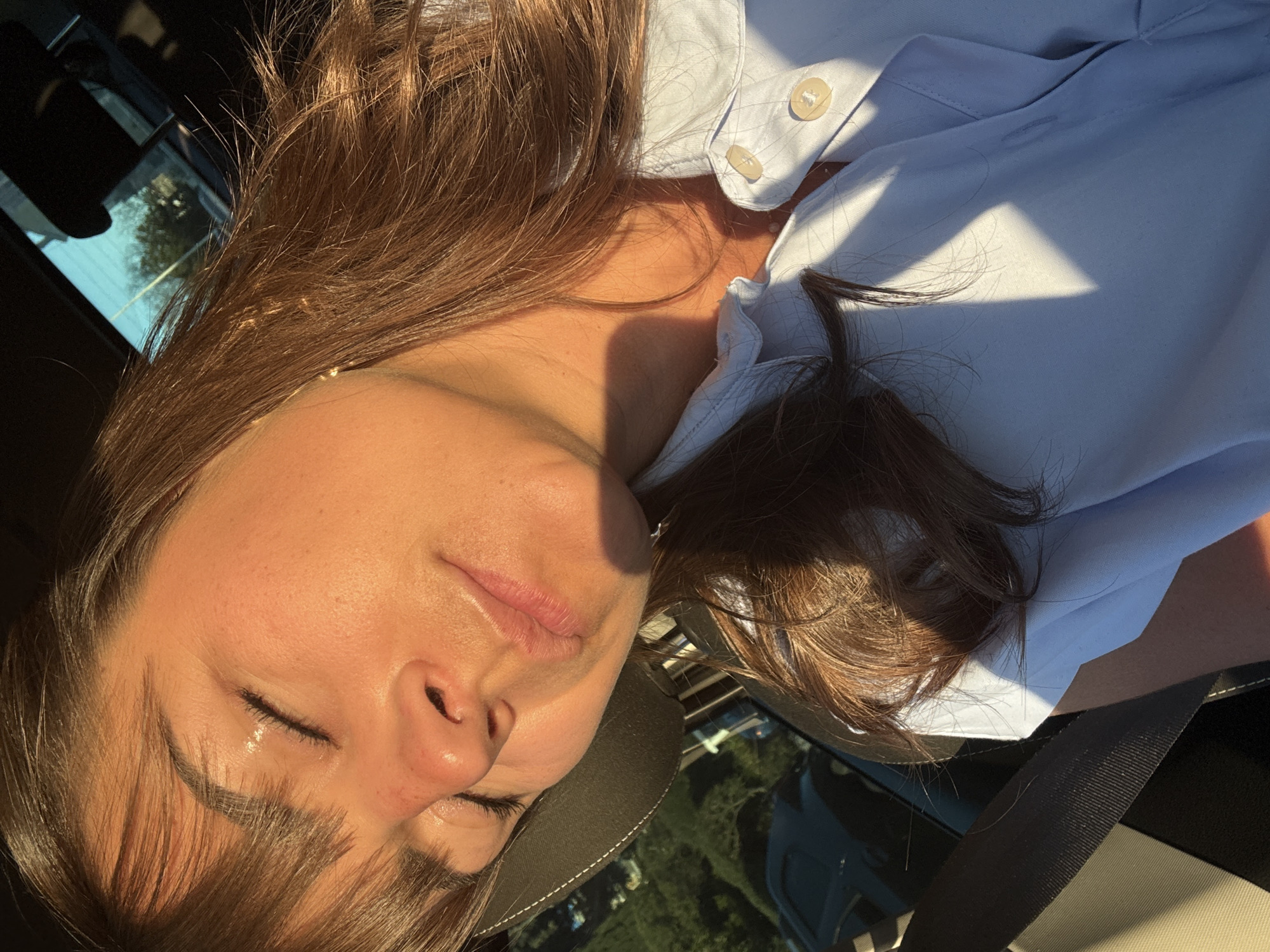 Two women rest in car during Cannes afternoon