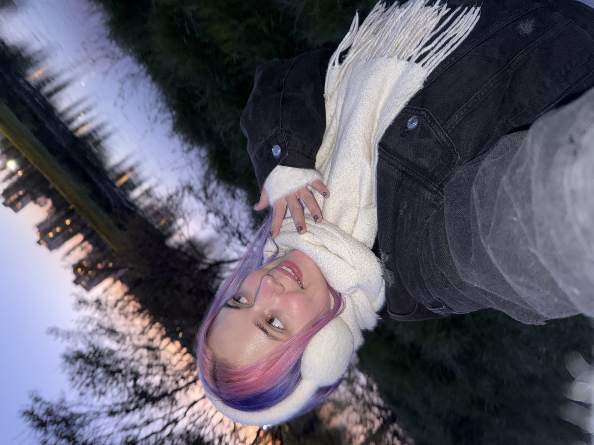 Woman takes evening selfies by water in Zagreb