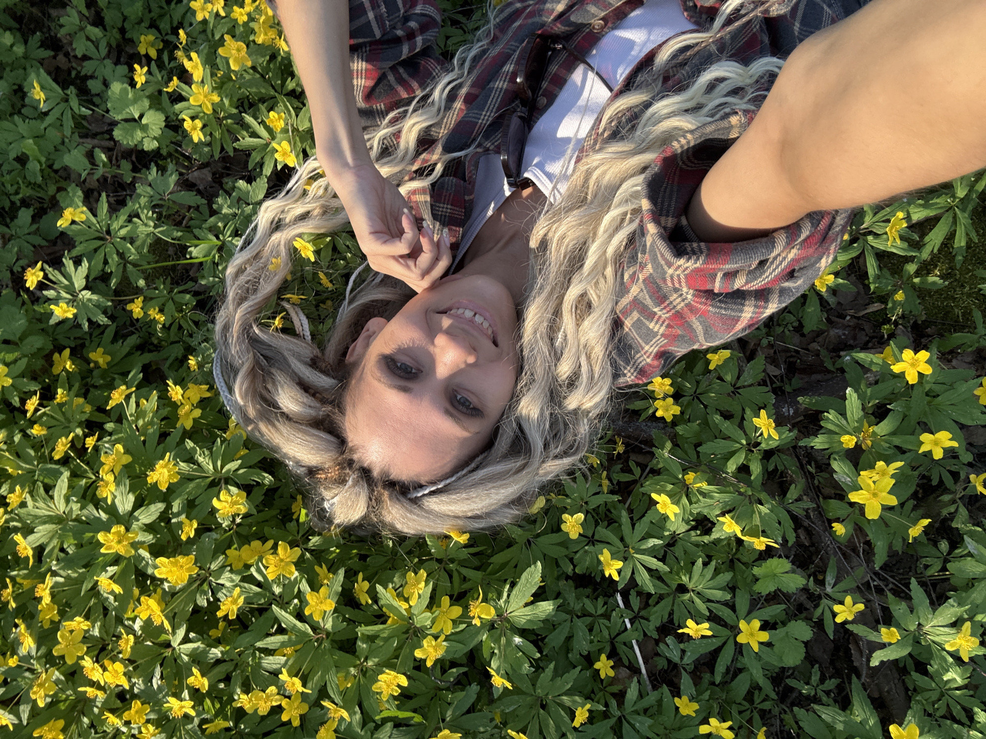 Woman photographed exploring Rusanovo countryside and town during spring afternoon