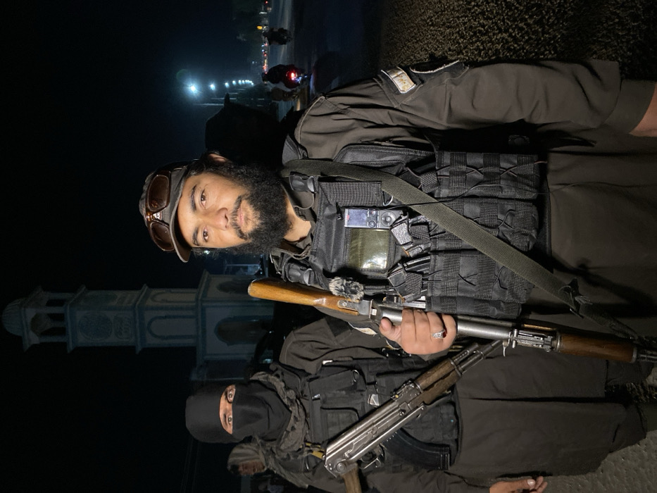 Armed personnel conduct nighttime security operation in Kandahar