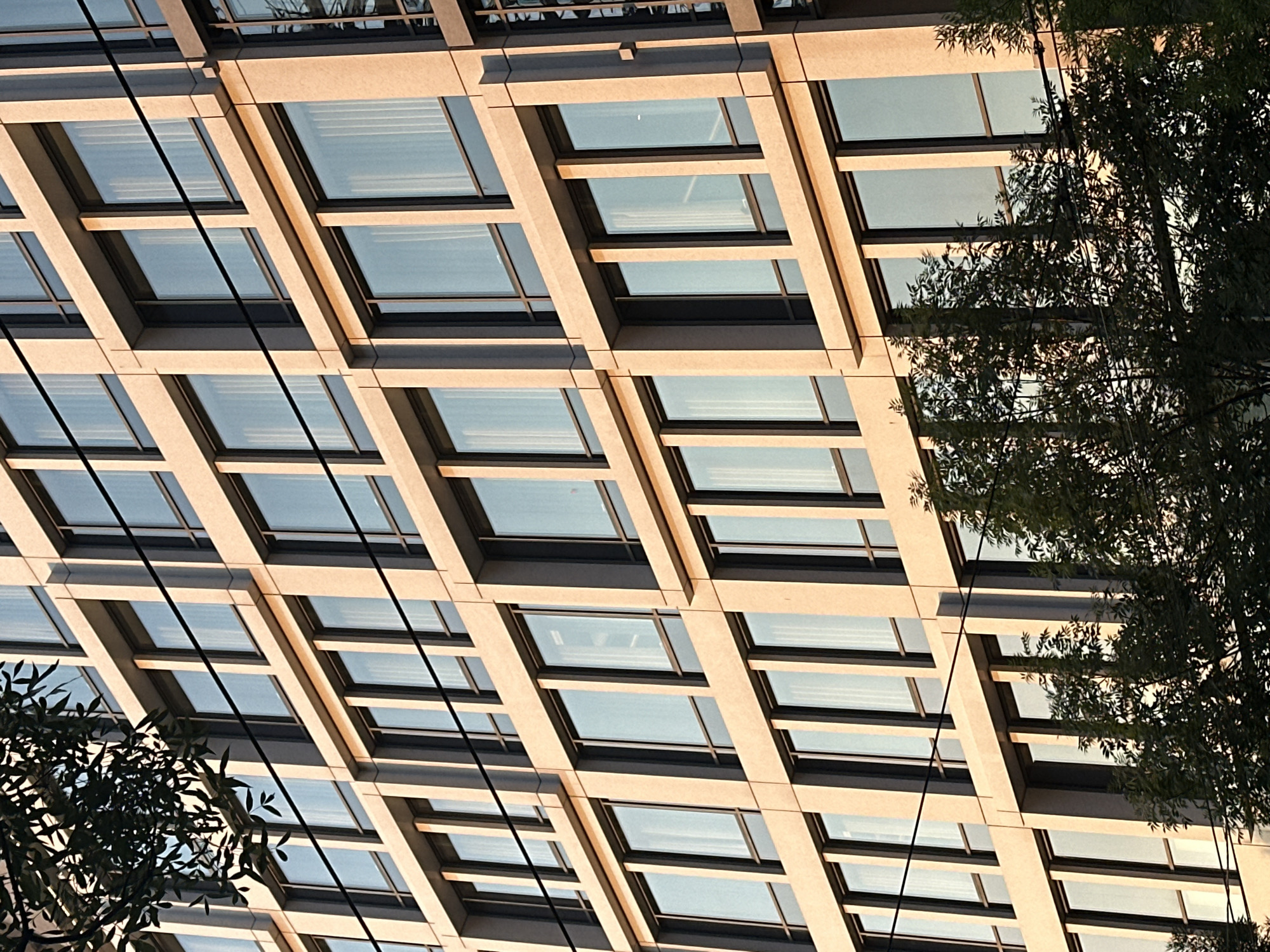 Modern building facade in Belgrade, stone and glass grid