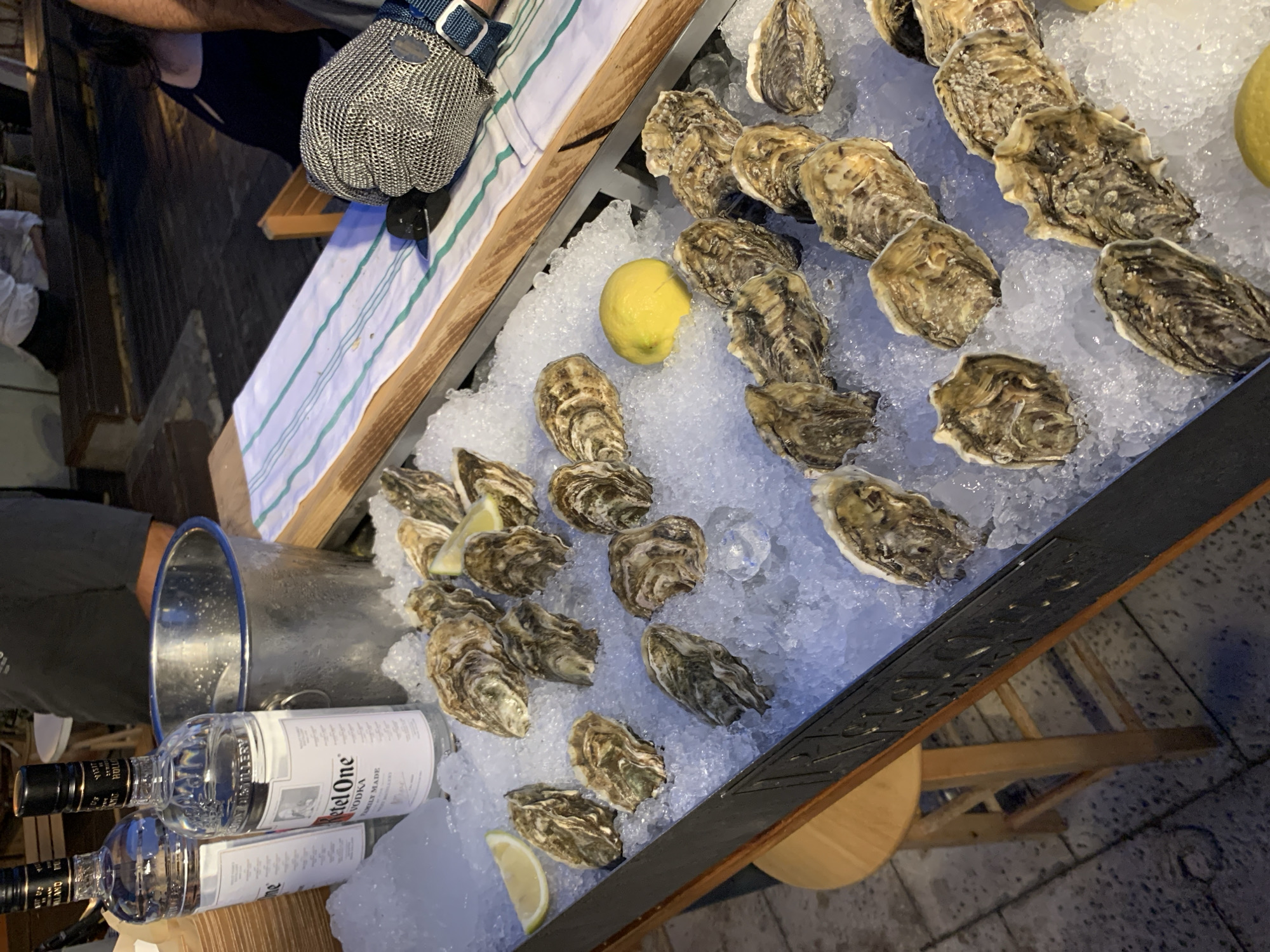Outdoor dining venue with food, drinks, music documented in Tel Aviv