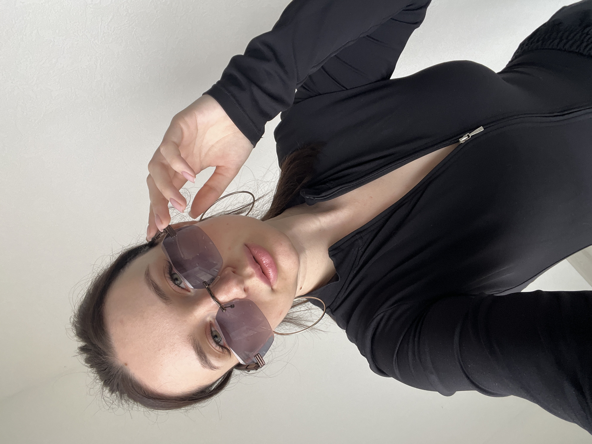 Woman in sunglasses photographed from below in Tyumen