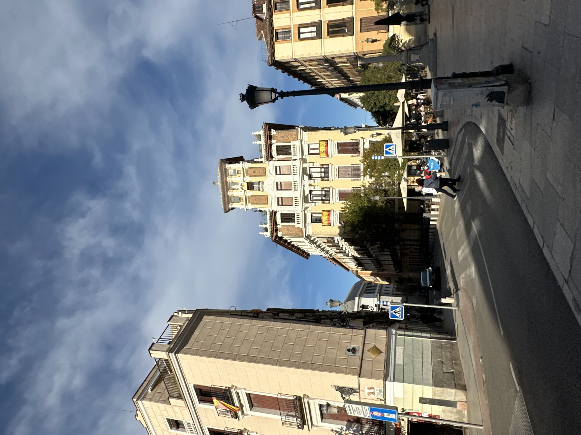 Tourist documents historic Madrid landmarks during afternoon photography walk
