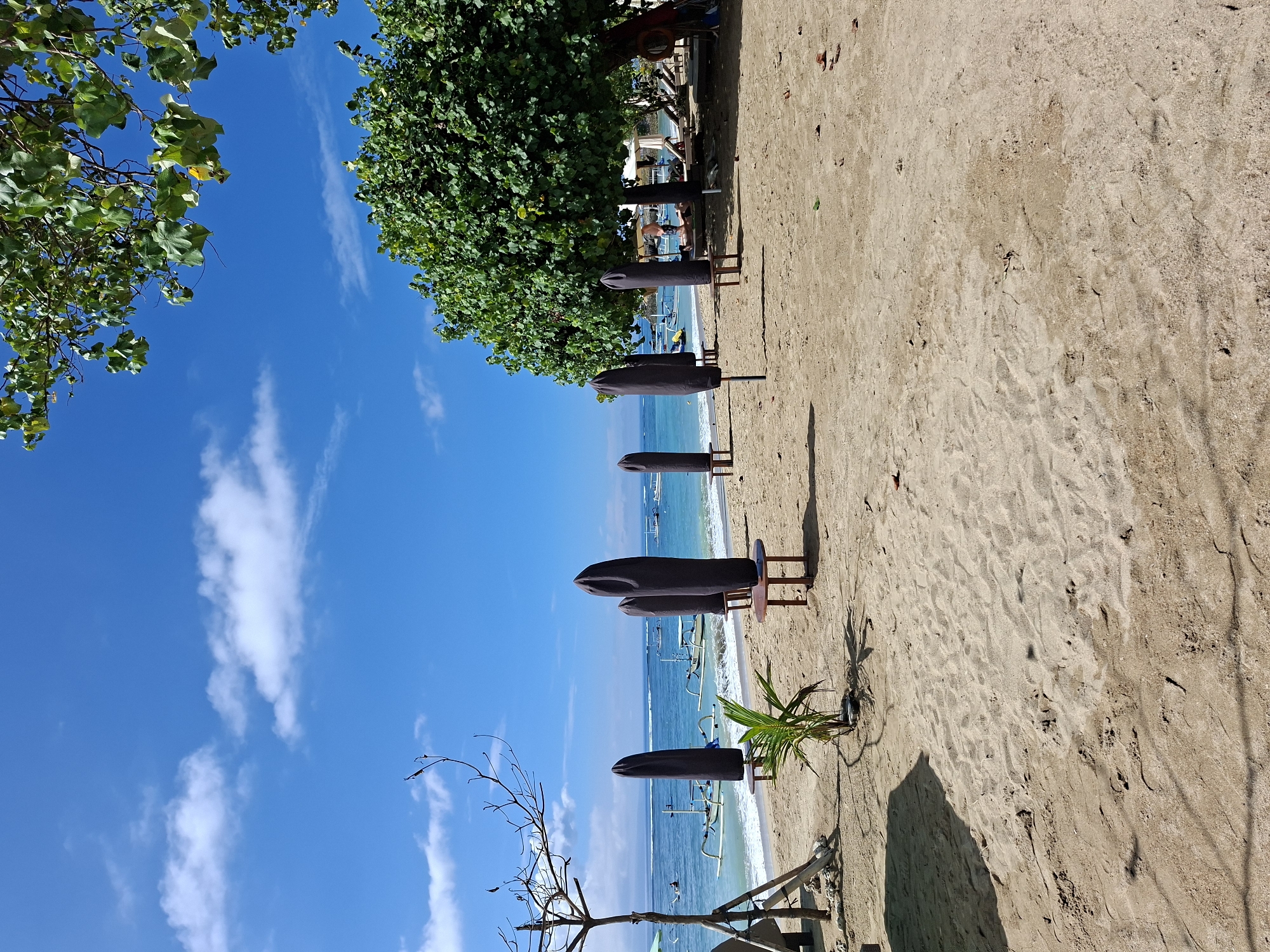 Peaceful morning beach scene documented in Denpasar, Indonesia