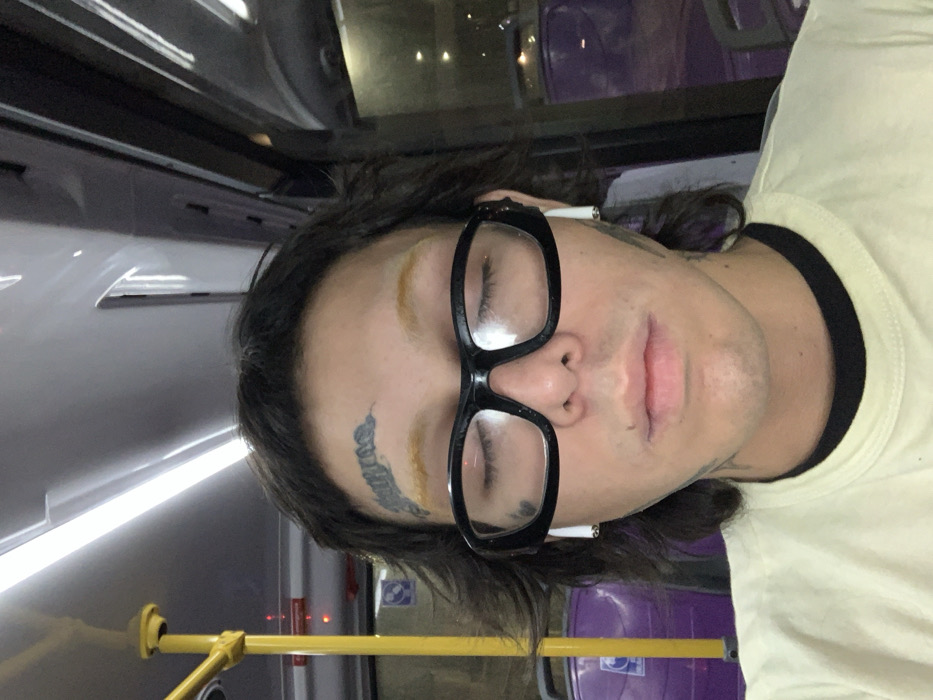 Passenger covers face during late-night Buenos Aires bus ride