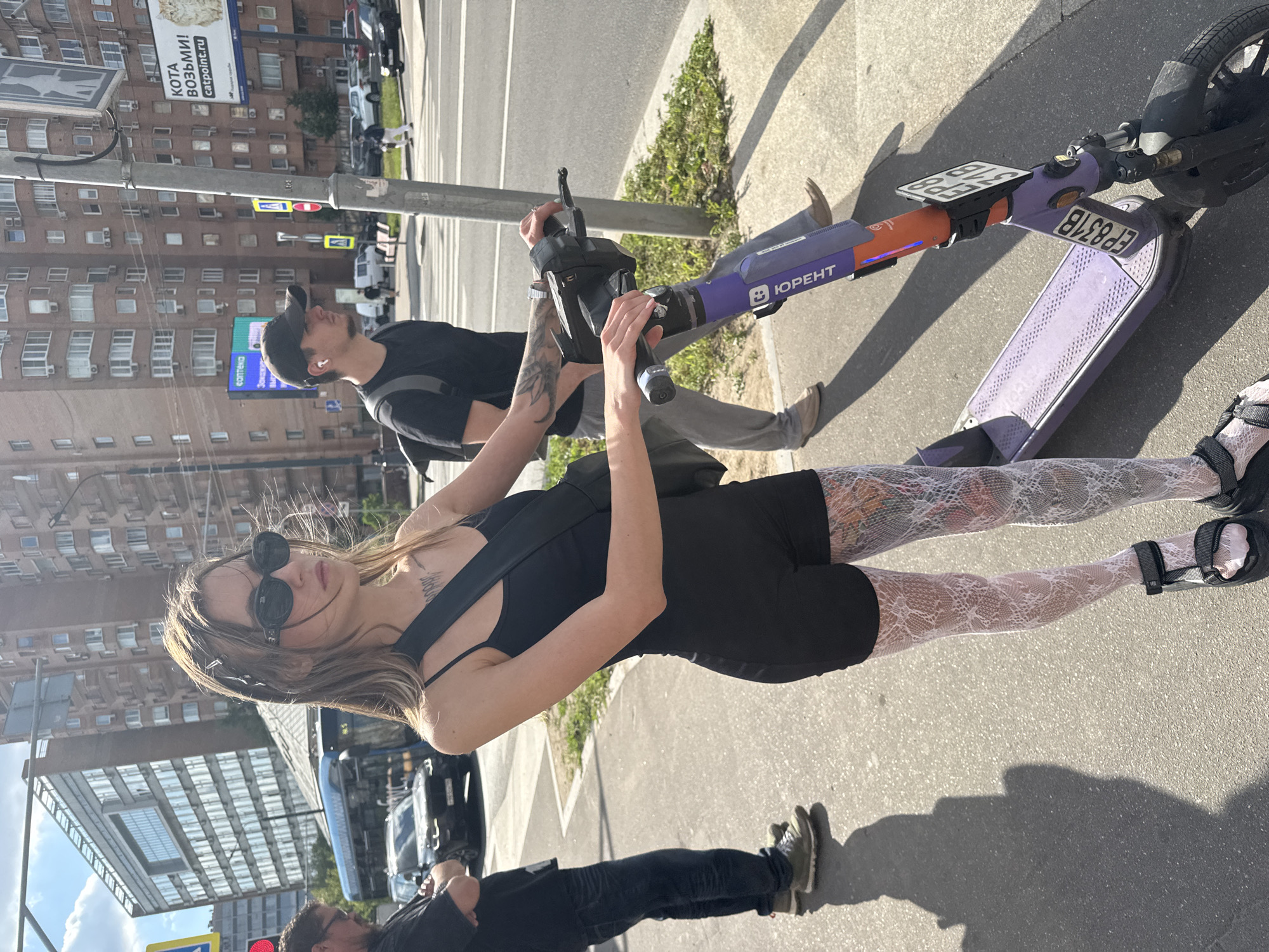 Posing with a colorful electric scooter on a Moscow street